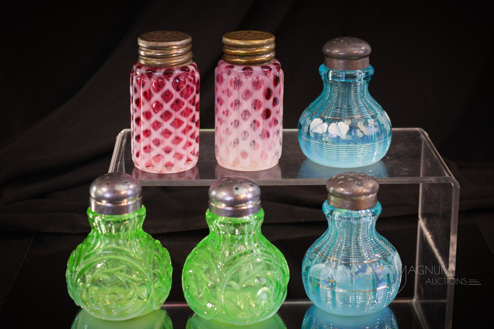 3 prs Victorian Glass Opalescent Glass Shakers: Three matched pairs of Victorian Northwood glass shakers. This offering includes a pair of green opal "Circle Scroll" pattern, a pair of cranberry "Ribbed Lattice" pattern, and a pair of blue opal dec