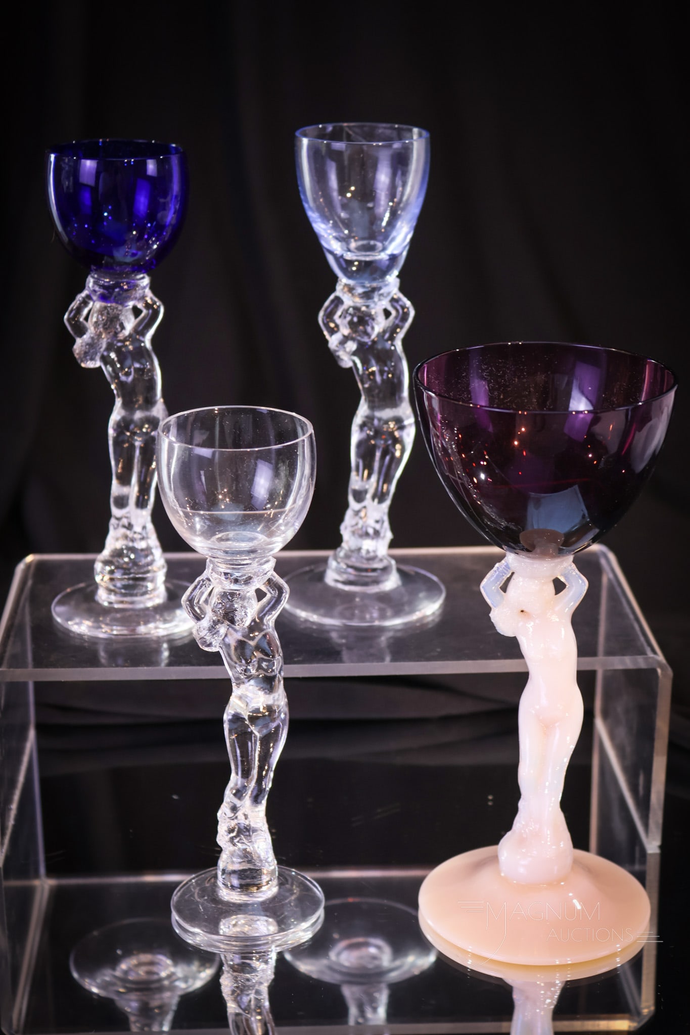 4 pc Lot Cambridge Glass Flirty Nude Stems: Four fun and slightly flirty Cambridge glass nude stemmed items. Tallest measures 6 1/2" tall. Includes amethyst and crown tuscan cocktail, moonlight blue brandy, royal blue cordial, and clear cordial