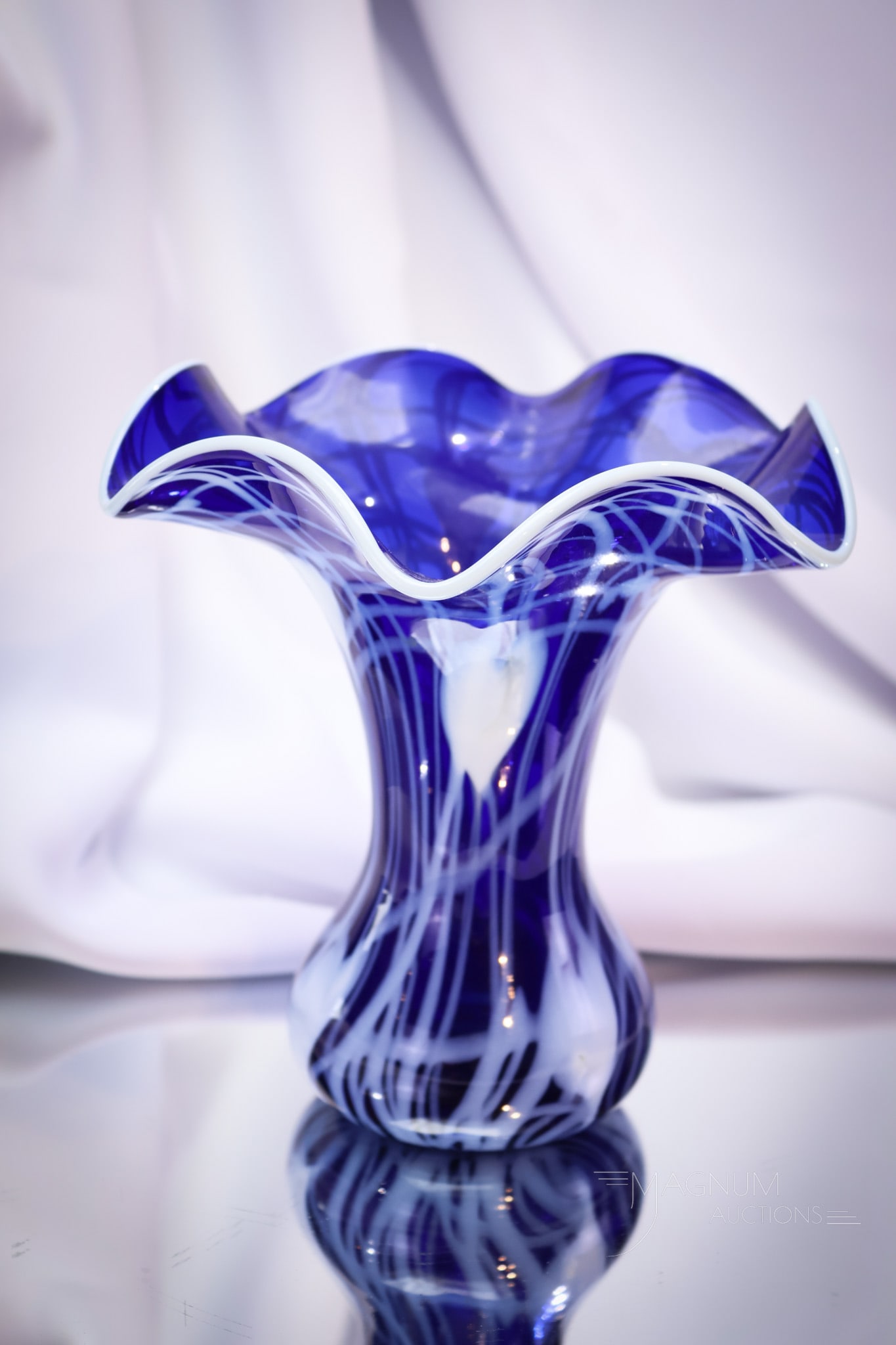 Imperial Freehand Cobalt Blue Heart & Vine Art Glass Vase: A fine example of Imperial freehand art glass. This vase measures 6 1/2" tall. The color of the ground is cobalt blue and is decorated with crisp white heart and vine decoration. Vase features a ruffl