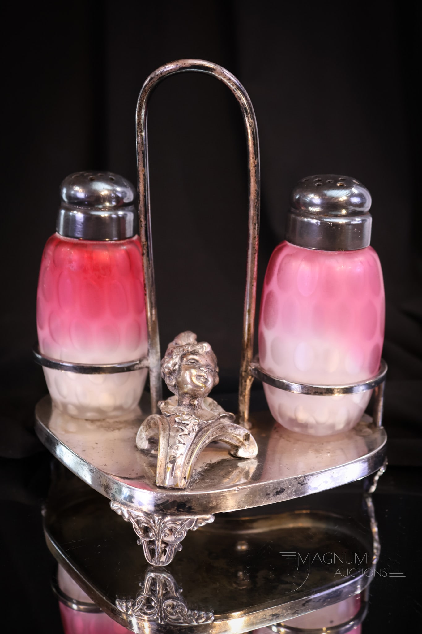 Victorian Meriden Silverplate Mother of Pearl Victorian Satin Glass Salt Shakers: Lovely pair of Pink mother of pearl satin glass salt shakers in the Coinspot pattern. These are set in a signed Meriden silverplate holder that is adorned with a female bust. Set measures 6" tall.