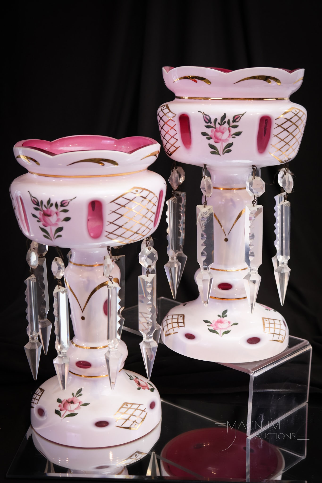 Pair Bohemian Cranberry Cut Overlay Art Glass Mantle Lusters: Fine pair of Bohemian origin cranberry cut overlay mantle lusters. Each is lavishly decorated with enameled florals. The pair measures 10 1/2" tall.