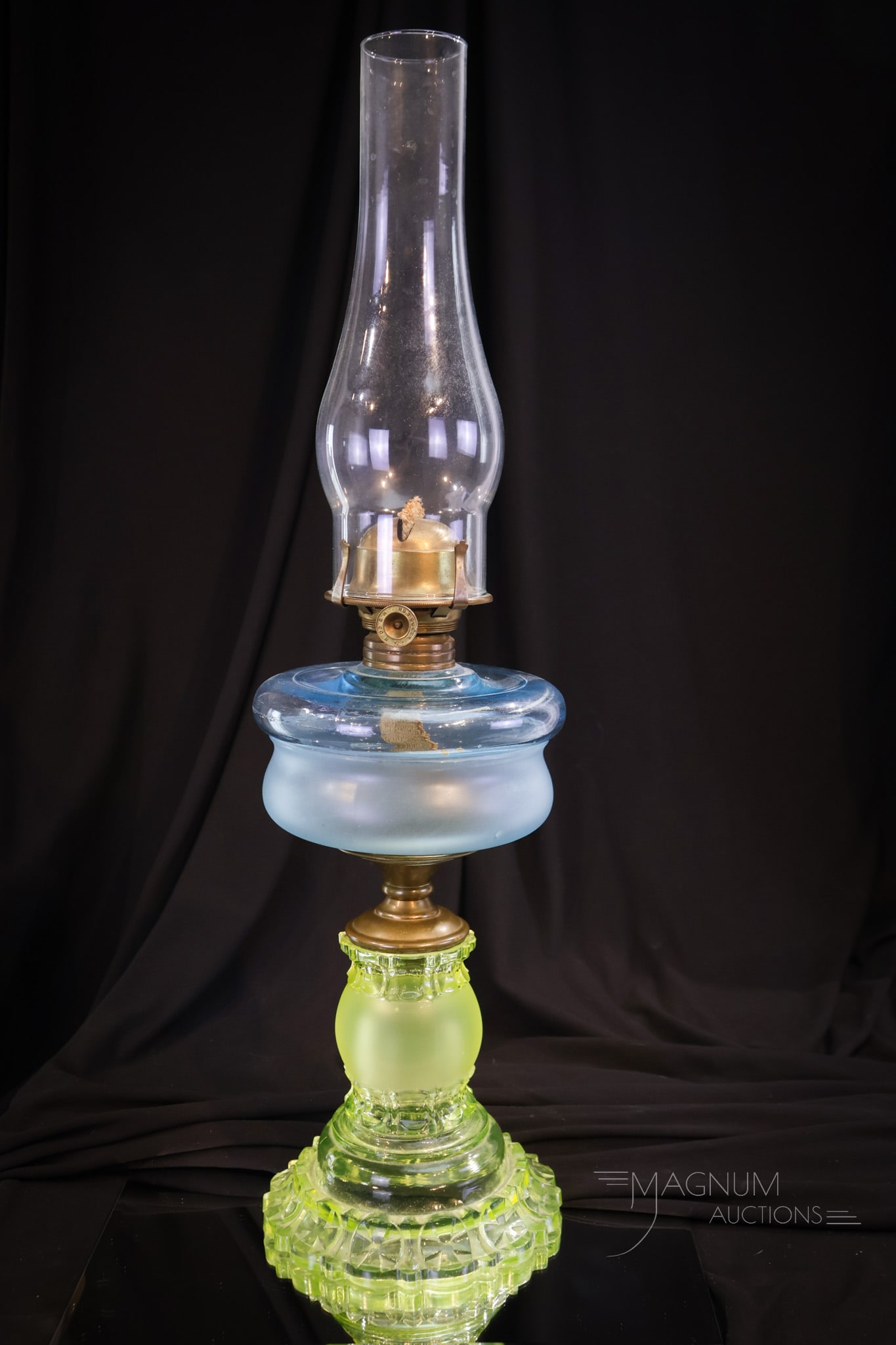 Adams Apollo Vaseline & Blue Victorian Glass Oil Lamp: A fine Victorian oil lamp. This is an Adams Apollo vaseline and blue oil stand lamp. The base is bright vaseline glass. The font is blue with frosting. Lamp measures 12" tall to the burner collar.