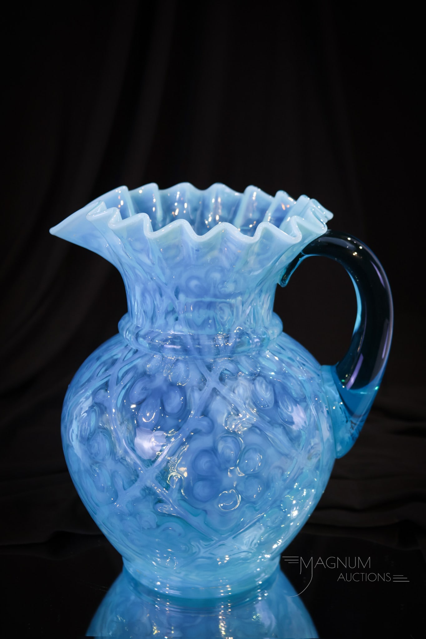 Northwood Daisy in Criss Cross Victorian Blue Opalescent Glass Water Pitcher: Heavenly shade of blue opalescent Northwood Daisy in Criss Cross water pitcher. This fine example has deeply ruffled rim. Ocean blue coloring. Pitcher measures 9" tall.