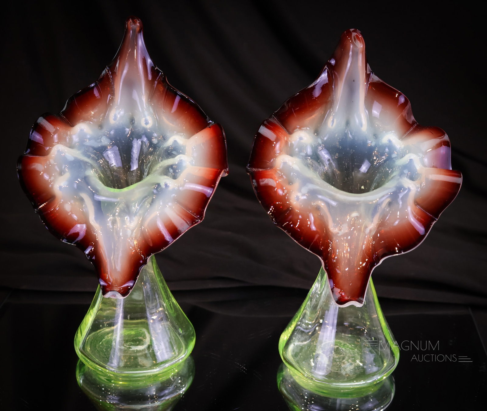 Pair Victorfian Vaseline & Oxblood Jack-in-the-Pulpit Vases: A matched pair of Victorian vaseline with oxblood rim Jack-in-the-Pulpit form vases. Each measures 7 1/4" tall.