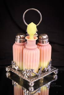 Rogers Silverplate Mt. Washington Burmese Uranium Glass Victorian Shaker Castor Set: A beautiful Victorian Mt. Washington Burmese uranium glass pillar mold condiment set in a signed Rogers silverplate holder. This fine set glows brightly under black light. The set is complete with