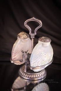 Mt. Washington Flemish Cockle Shell Salt Shakers Victorian Silverplate Castor: A charming signed Beaverdam Silver Co. figural donkey holder with a pair of Mt. Washington flemish glass cockle shell form salt shakers. One is in translucent with blue coloring. The other is in trans