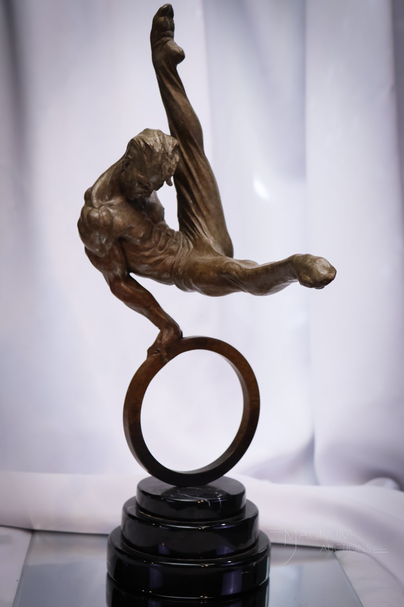 Richard MacDonald signed "The Flair" Gymnast Bronze 20 1/4" Sculpture: A beautiful 20 1/4" tall Richard MacDonald bronze titled, "The Flair" and signed, "R.MacDonald, 95." bronze on black marble base. This gymnast figure is captured in a moment.