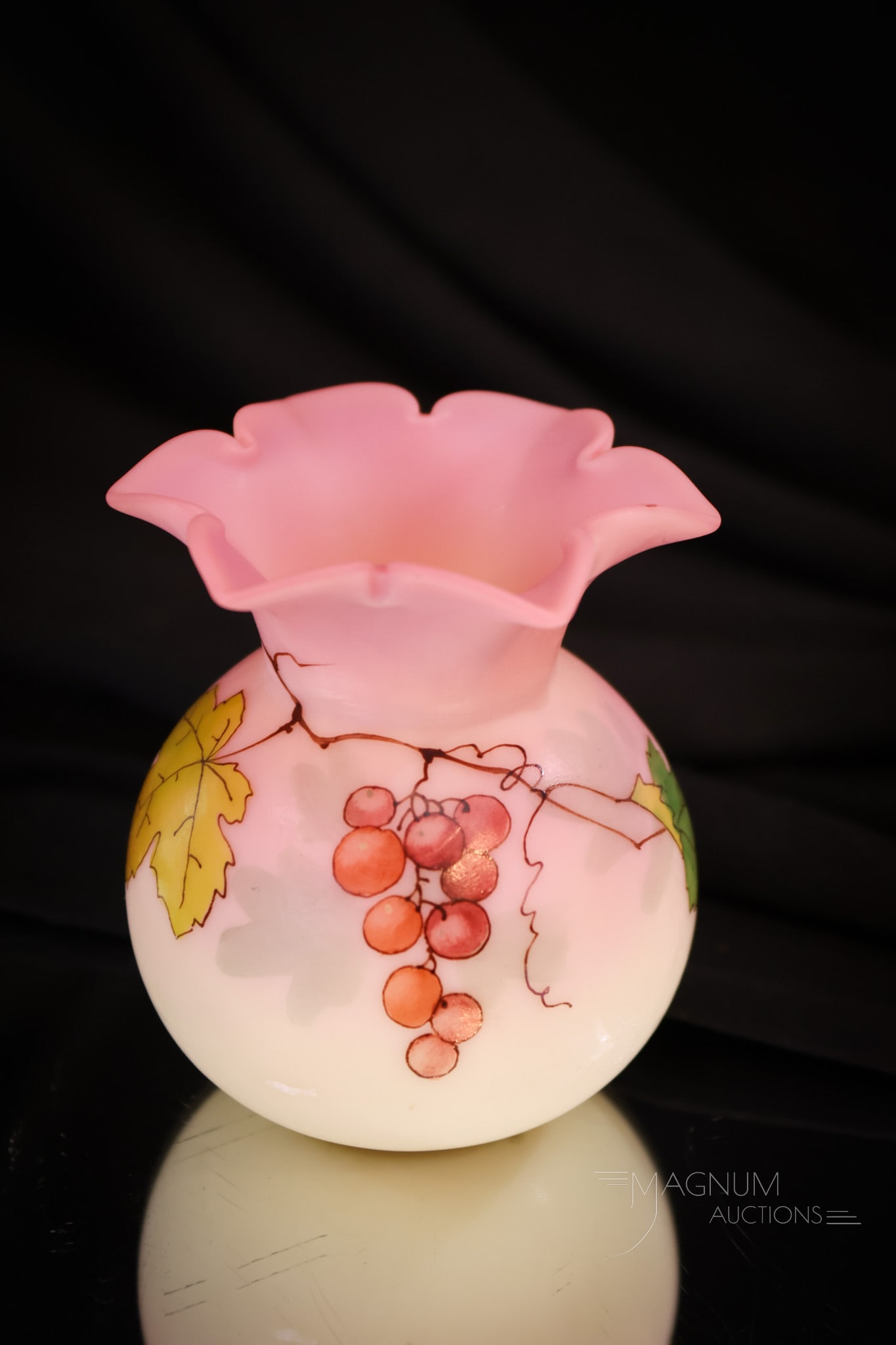 Webb Burmese Victorian Glass Star Top Posey Vase: A gem among gems! This star top rim vase by Webb is lovely in their burmese glass. This honey is decorated with berries. Vase measures 2 7/8" tall.