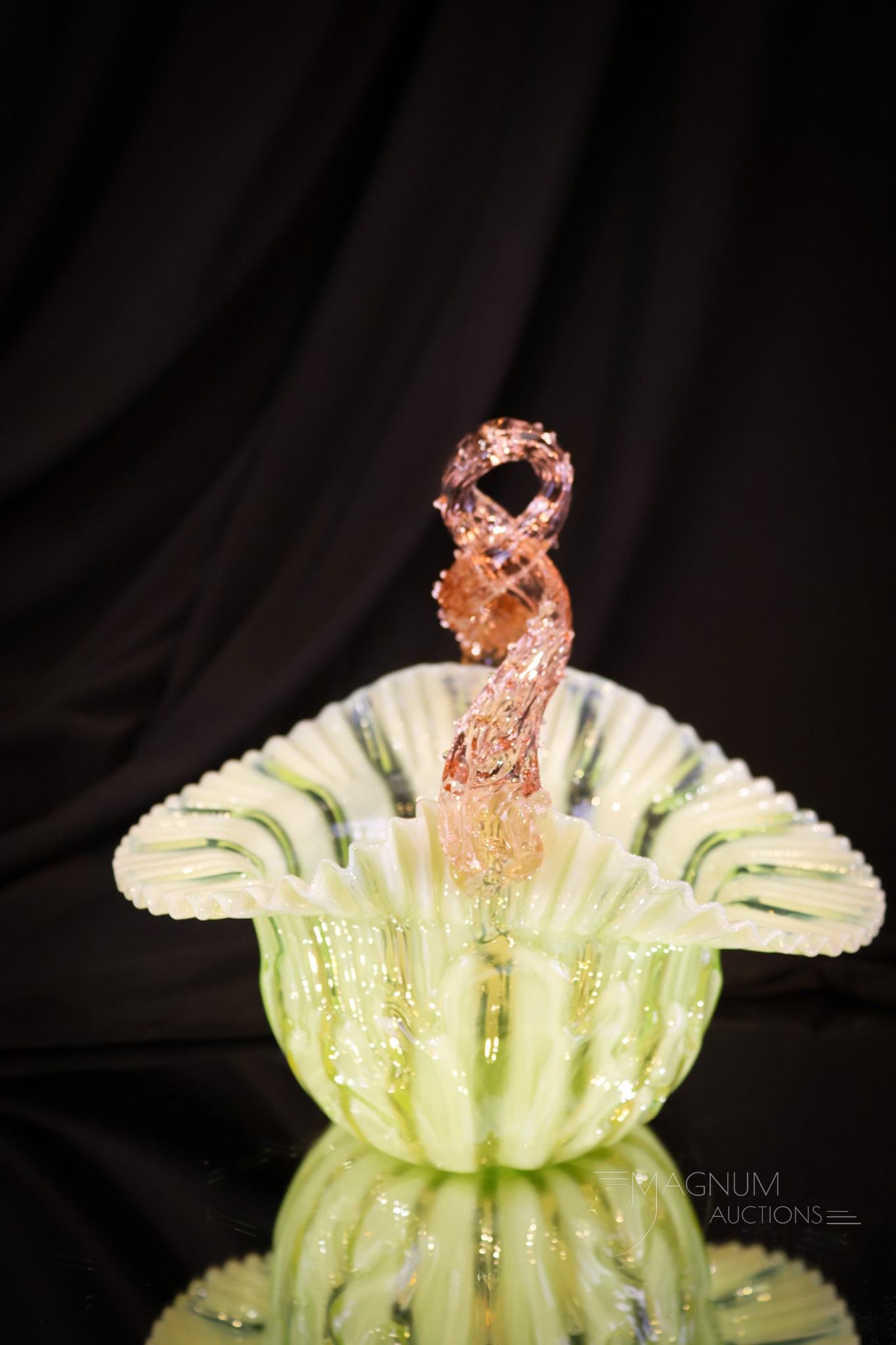 Victorian Uranium Green Opalescent Stripe Embossed & Pink handle Art Glass Basket: A glowing basket for your growing collection. This fine example is made in uranium-rich green Victorian glass with an opalescent stripe pattern. The handle is a twisted thorny pink glass. The body of 