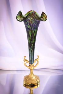 Austrian Iridescent Art Glass 9 3/4" Vase in Gilt Holder: What a lovely find this super piece is! This vase is iridescent Austrian art glass. It resides in a gilt metal original base. Complete this offering measures 9 3/4" tall.