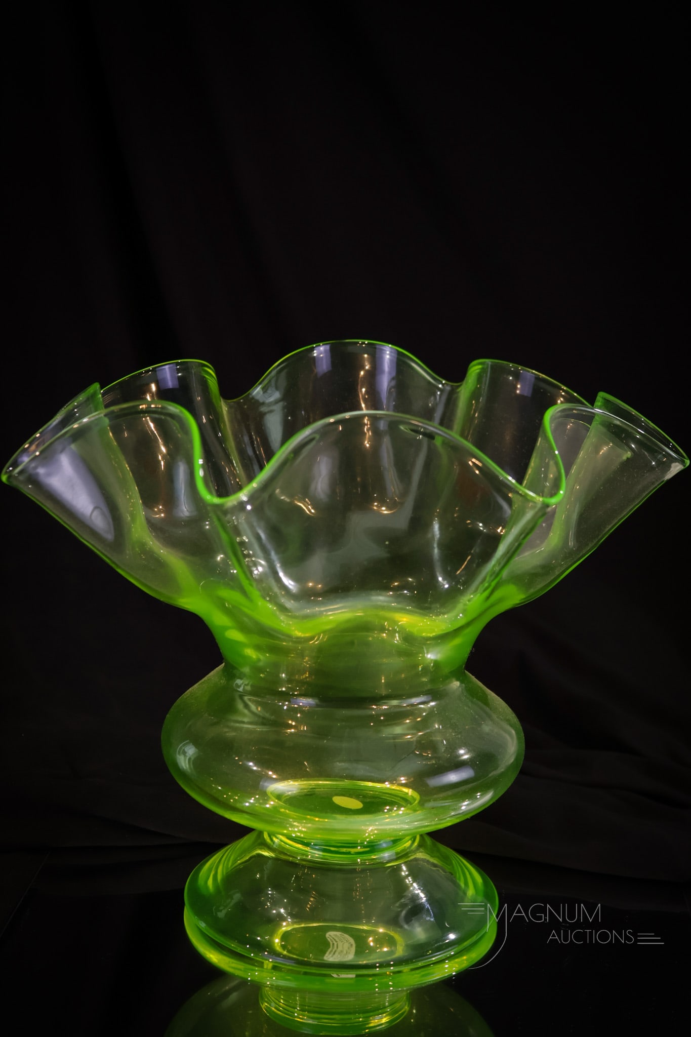 Monumental 11 1/2" Vaseline Glass Ruffled Fruit Center Bowl: A monumental find in vaseline glass. This large fruit or center bowl measures 9 1/2" tall, and 11 1/2" in diameter. It lights up brilliantly under black light. This piece is of unknown origin. A wonde