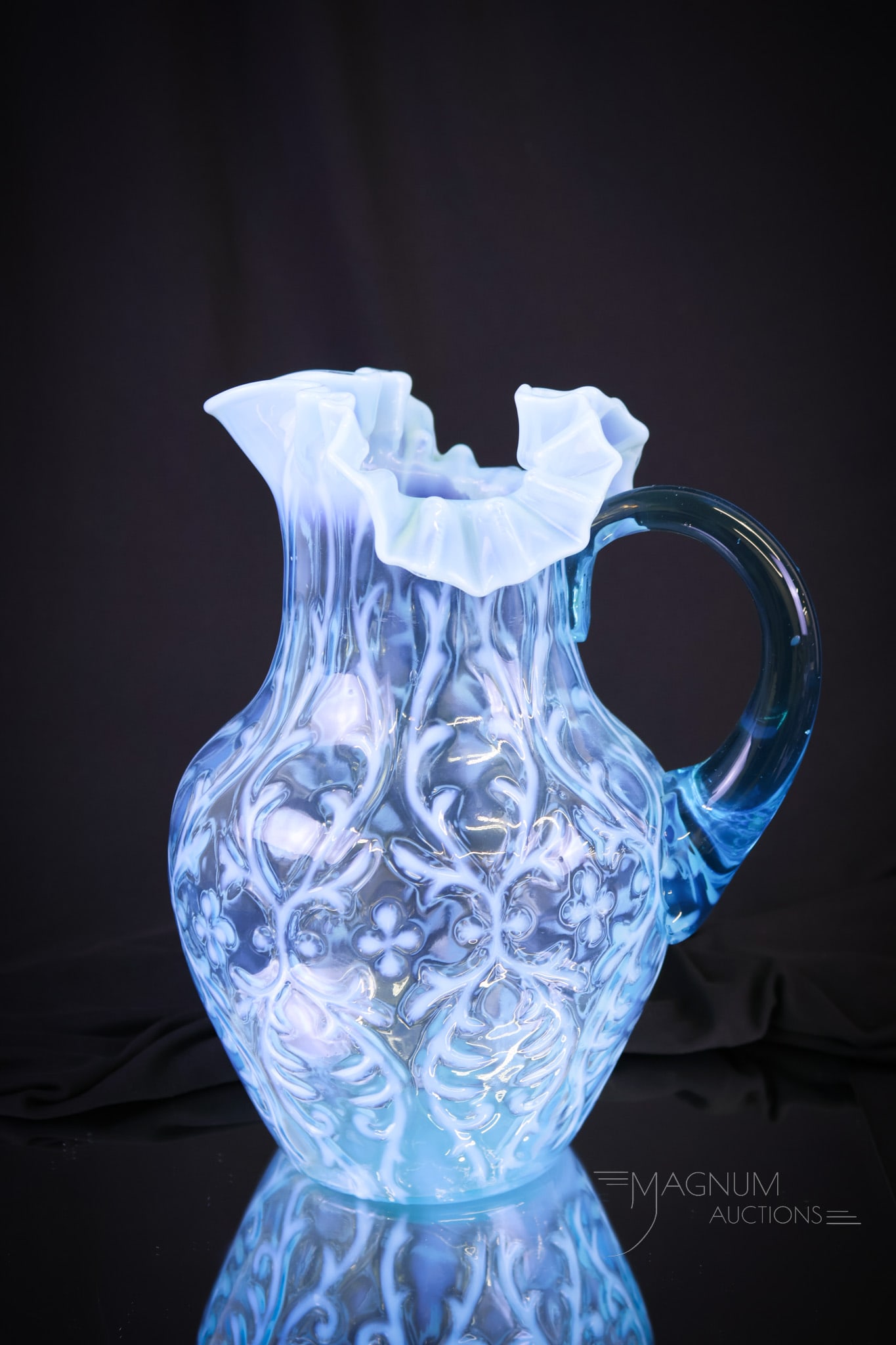 Northwood Blue Opalescent Spanish Lace Victorian Glass Water Pitcher: A fine example of a Northwood blue opalescent Victorian glass water pitcher in the Spanish Lace pattern. This pitcher has strong opal and coloring. The piece measures 9 3/4"" tall. Provenance: This i