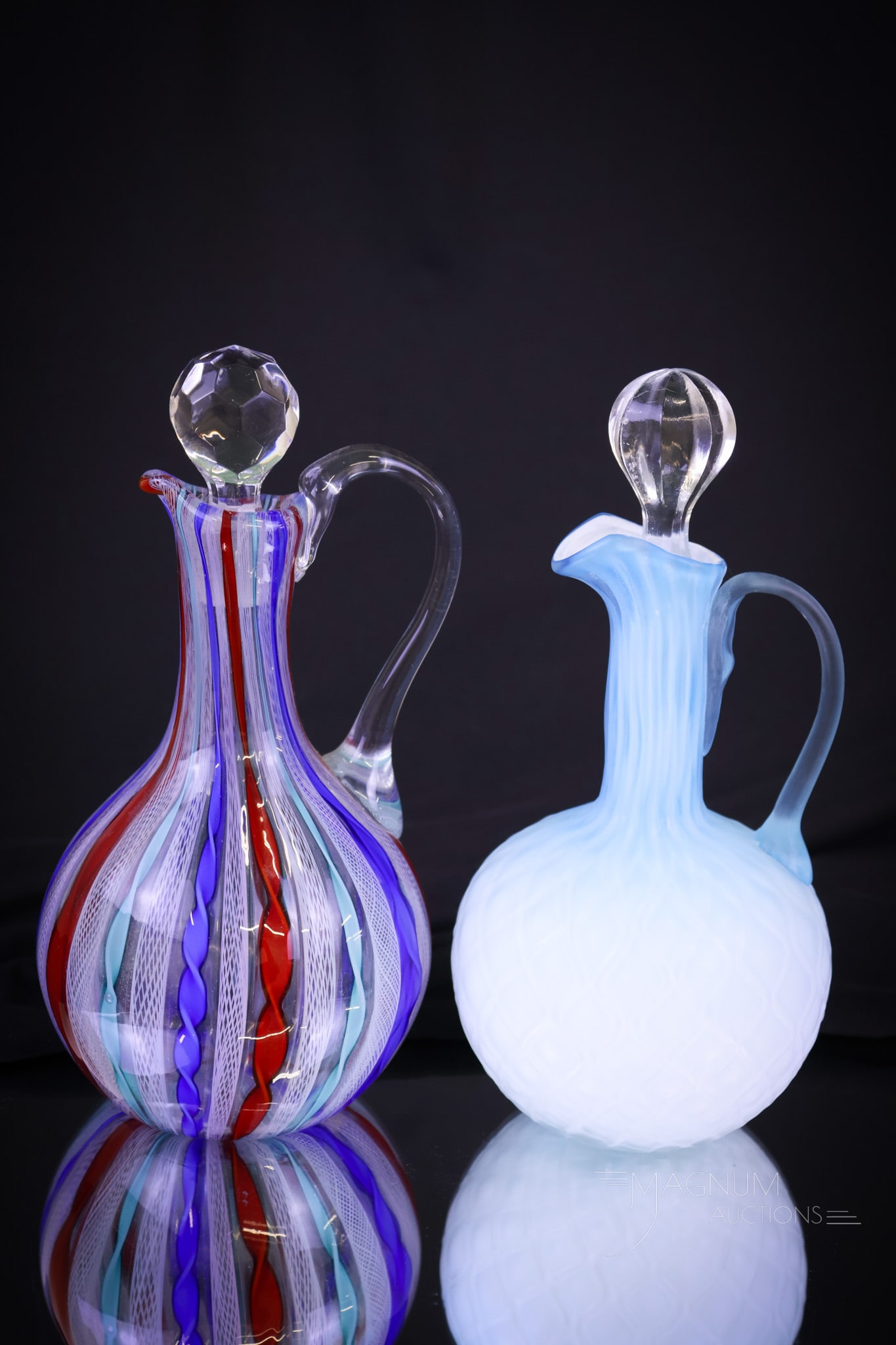 2 pc Lot Italian Latticino & Mother of Pearl Art Glass Cruets: Two distinct examples of Italian art glass cruets. The first is a red, blue, and aqua Latticino glass example. The second is a blue satin Diamond Quilt Mother of Pearl. Shipping: At checkout, select "
