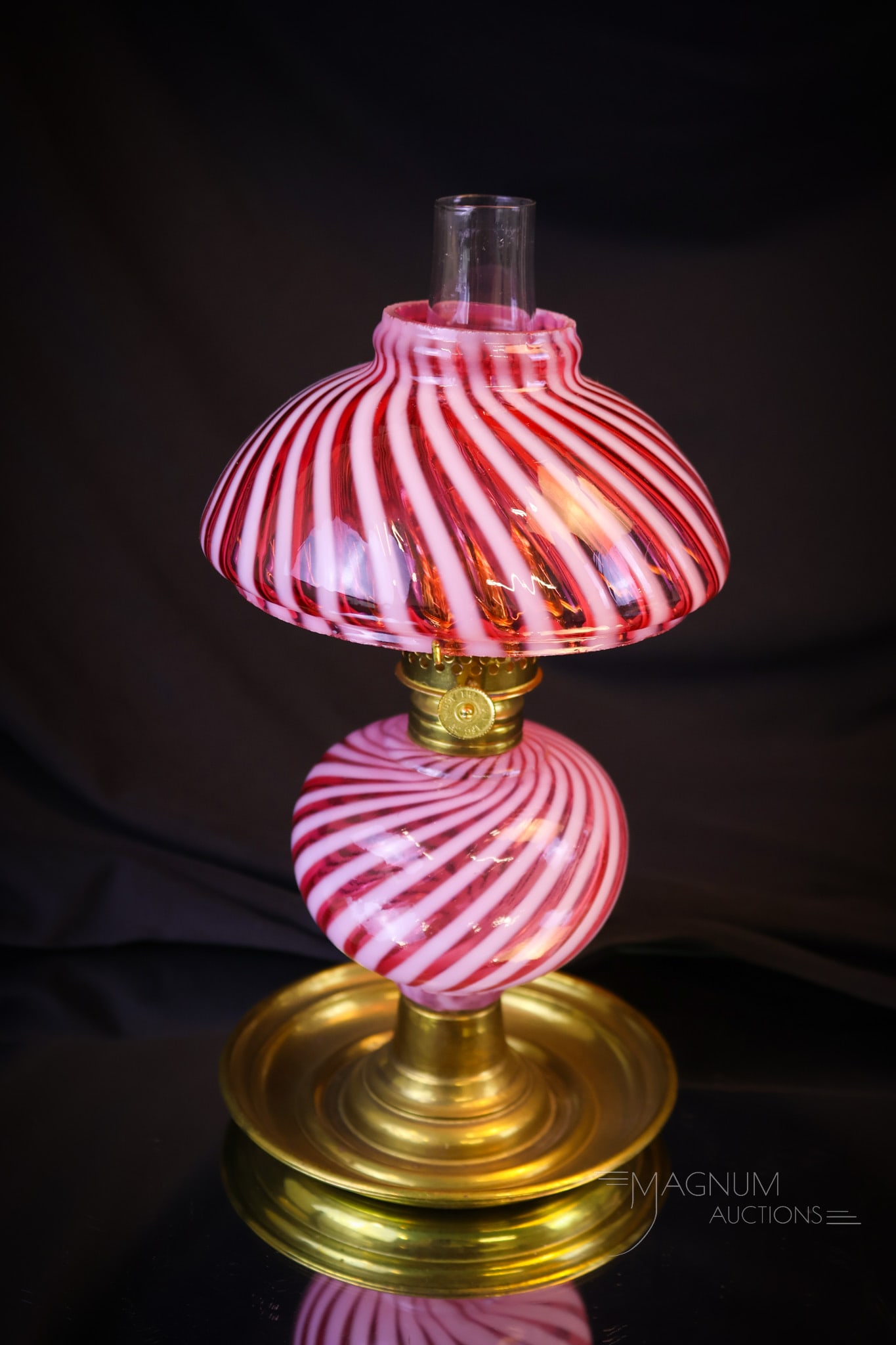 Victorian Rare Cranberry Opalescent Swirl Miniature Oil Lamp: Another rare find in our auction. This is a cranberry opalescent swirl miniature oil lamp. This lamp is complete with its original matching shade and brass foot. This lamp measures 7 1/2"" tall and 4 