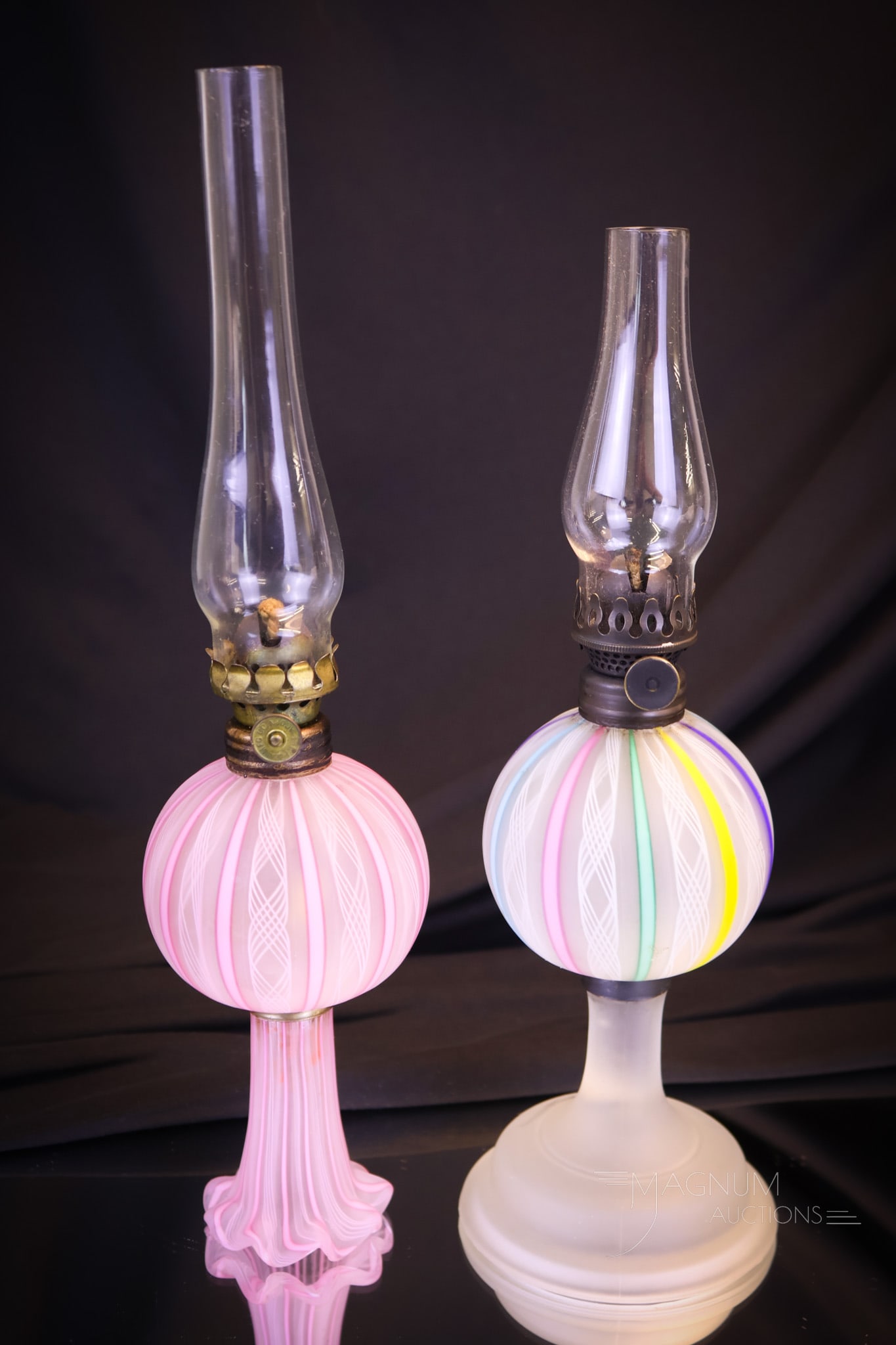 2 pc Lot Italian Murano Latticino Art Glass Oil Lamps: Two unique examples of Italian Murano Latticino art glass oil lamps. A rainbow example along with a ruffled foot pink example. The tallest measures 6 1/4"" tall to the burner collar. Shipping: At chec