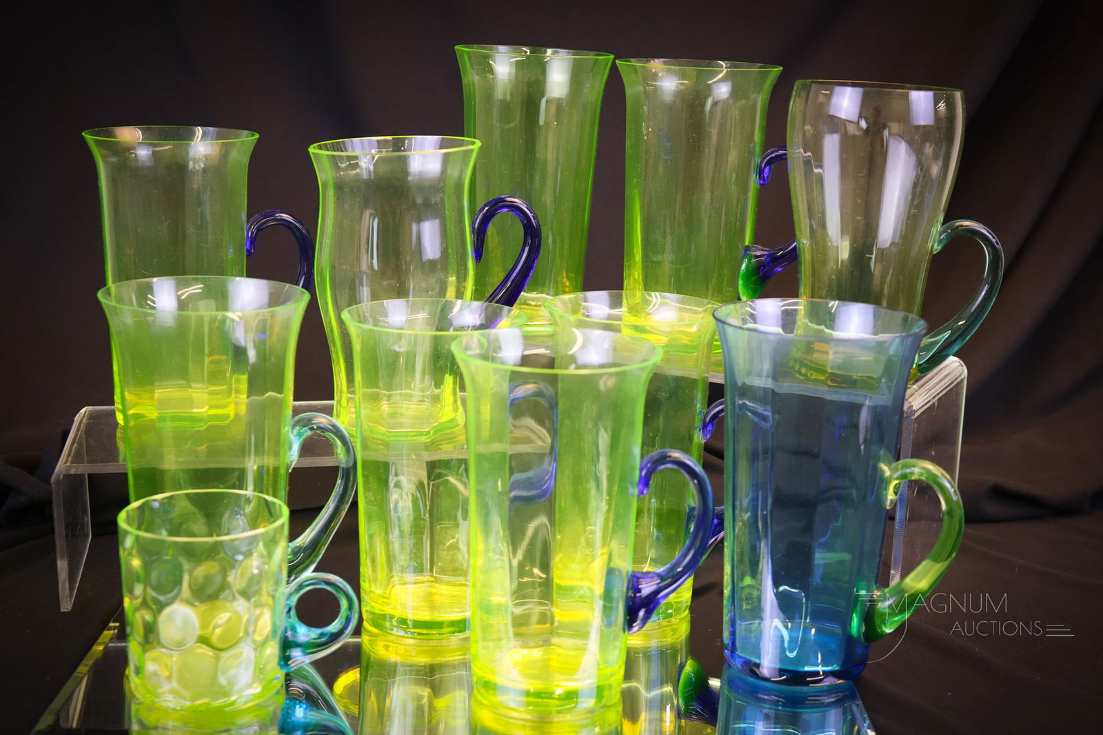 11 pc Lot Vaseline & Blue Glass Tumblers: A more than generous lot of vaseline and blue glass tumblers in many color variations. The tallest measures 5 1/2"". Four examples exhibit rim chips. Shipping: At checkout, select ""Arrange your own