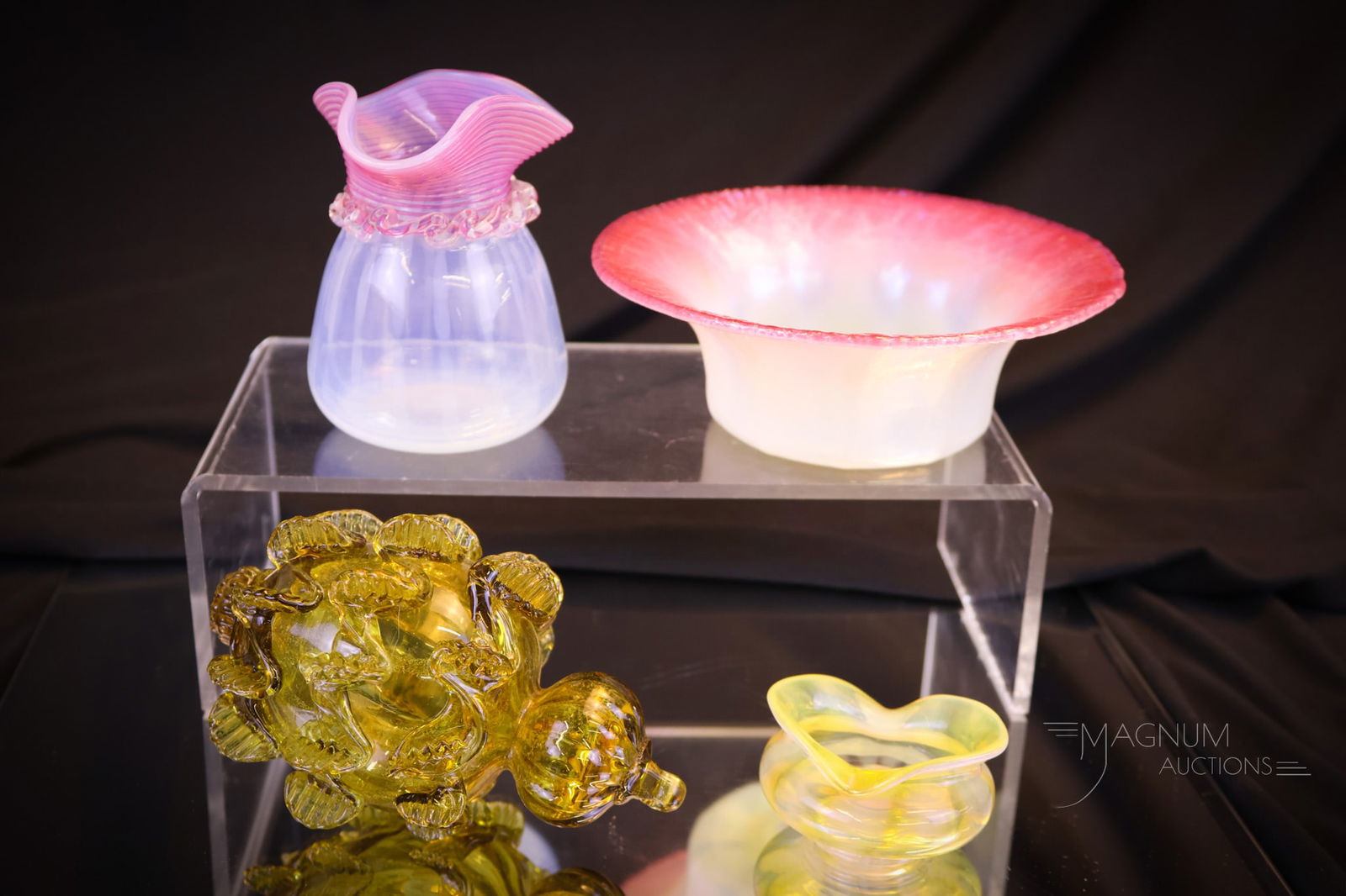 4 pc Lot of Splendor in Art Glass: This lot includes various forms of art glass. The first is a Monet Stumpf opal open salt. Another piece is an opal cabinet vase with pink threading and rigaree. The third piece is a Tiffany pastel fin