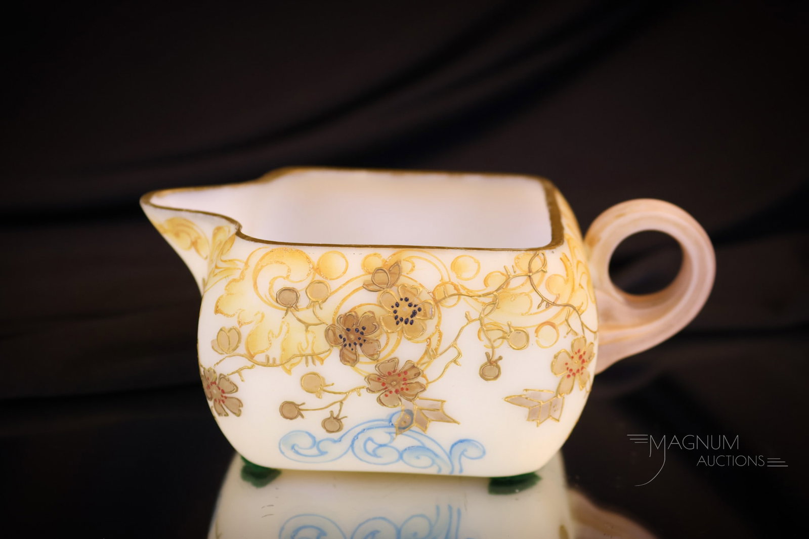 Mt. Washington Victorian Glass Crown Milano Creamer: Another fine piece for your collection. This is a creamer in Mt. Washington's Crown Milano glass. This cream pitcher is decorated with florals around. It measures 2" tall and 5" wide. Shipping: At che
