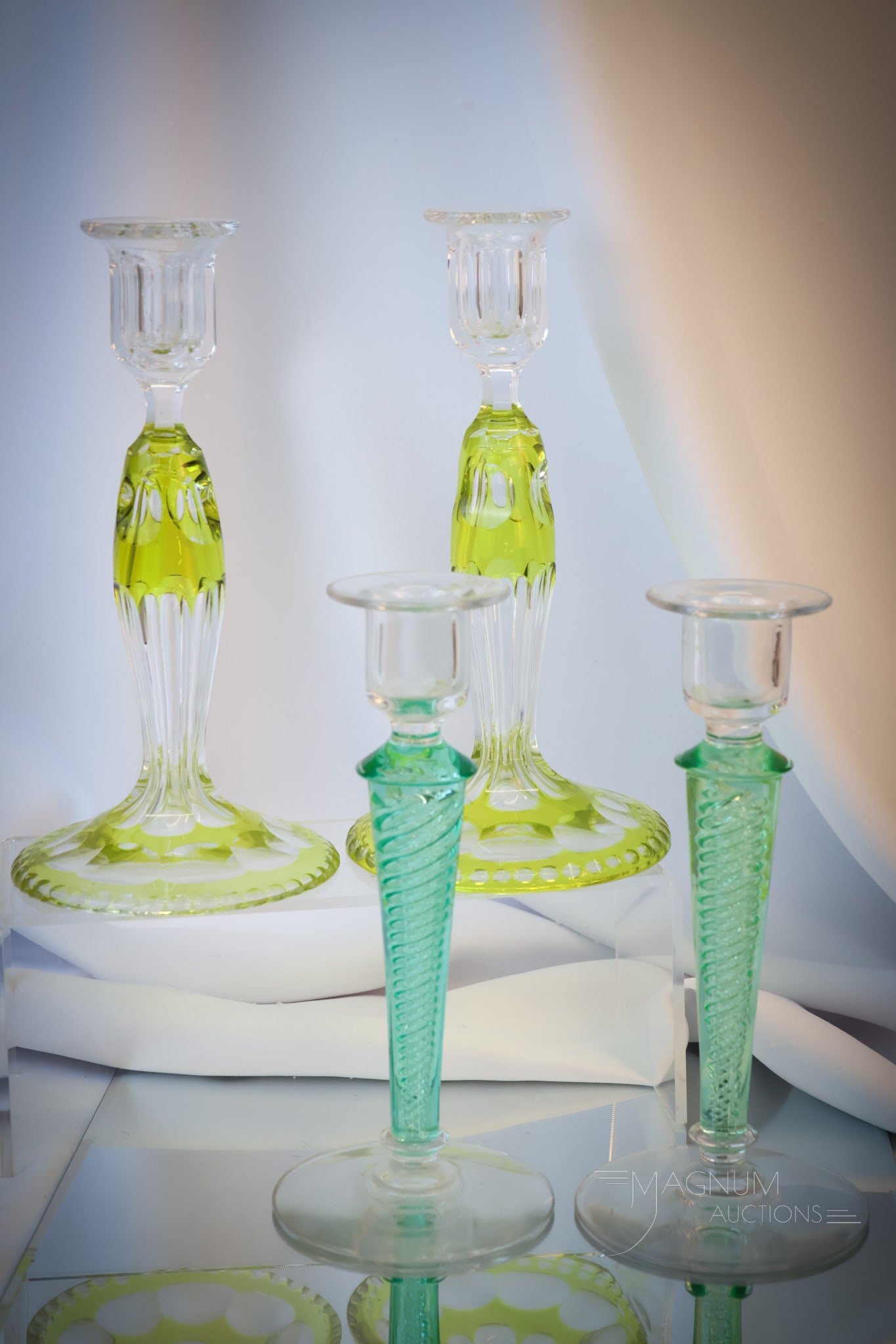 2 pair Lot Cut Overlay Air Twist Glass Candlesticks: Two desirable pairs of candlesticks for your bidding pleasure. This offering includes a pair of citron cut overlay examples. There is also a pair with aqua color stems with airtrap twist stems. The ta