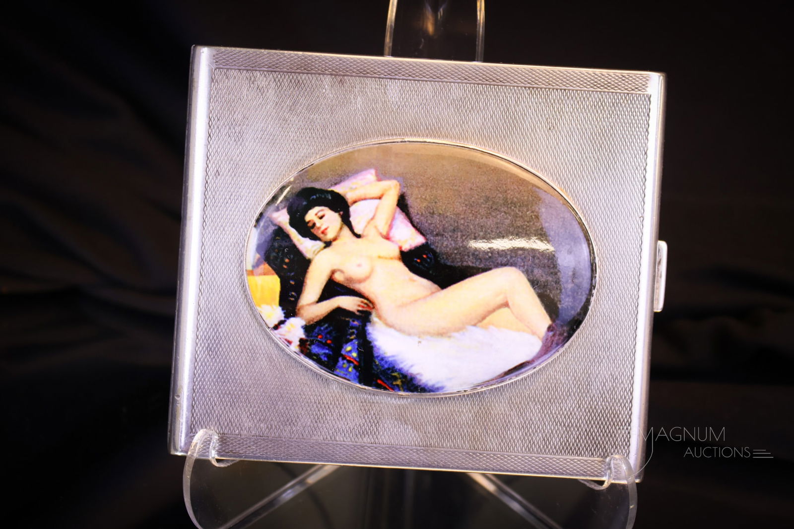 English Sterling Silver Nude Enameled Hallmarked Cigarette Case: A beautiful sterling silver hallmarked cigarette case, complete with hallmarks. This beautiful example has an applied plaque of a reclining brunette nude lady. Hallmark indicates circa 1918-1925, and