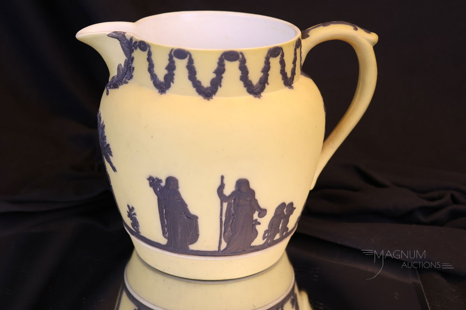 Wedgwood Basalt Over Mustard Jasperware Jug: A super example of a collection-enhancing piece of Wedgwood basalt over mustard Jasperware in the form of a jug. This is a great example with good coloring and definition. The jug measures 5 1/4" tall