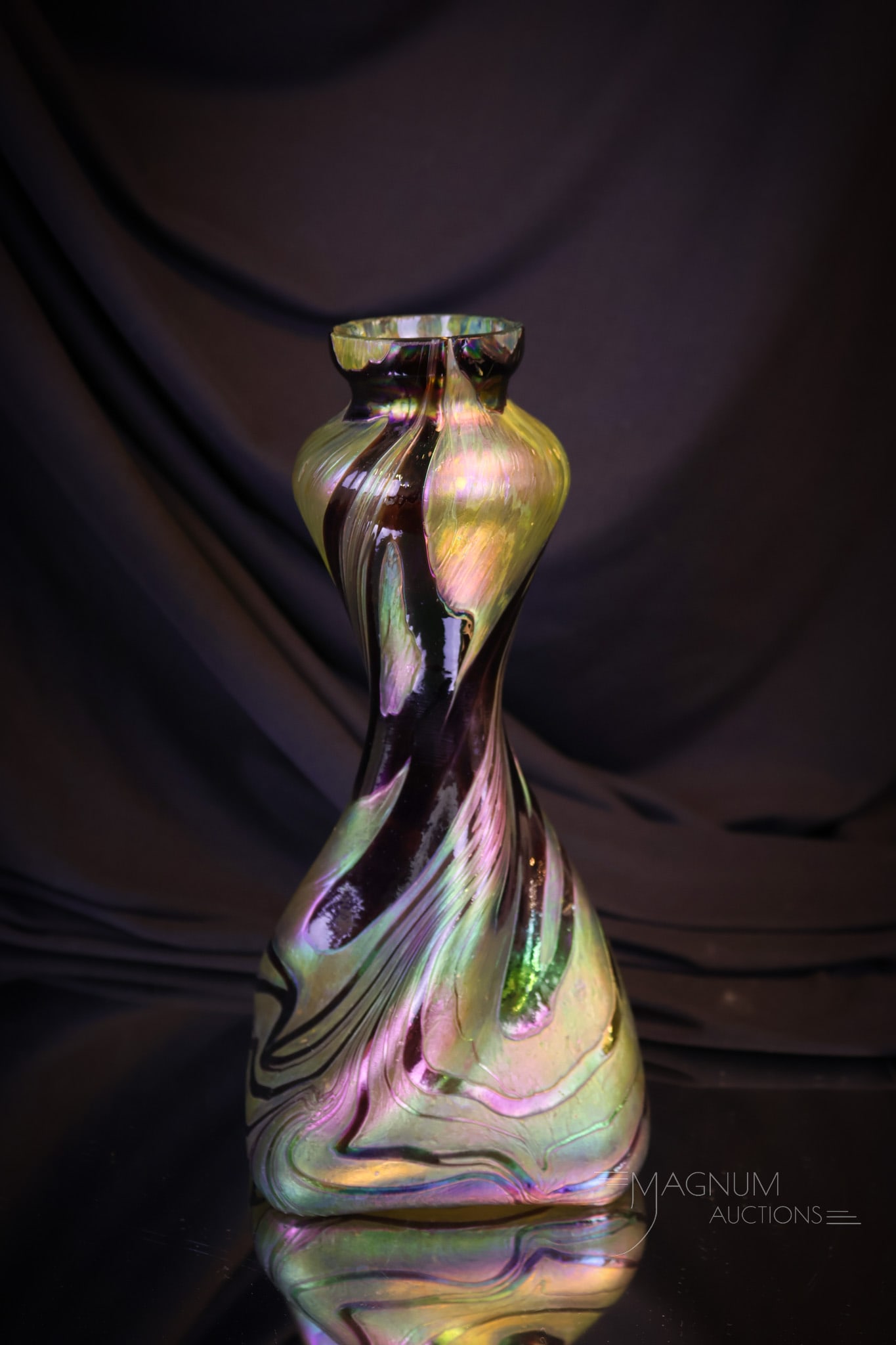 Kralik Iridescent Art Glass Vase: A beautiful Kralik art glass iridescent vase. The vase features a burgundy swirl on gold iridescent ground and a square form base. This vase measures 9" tall and 4" wide. Shipping: At checkout, select