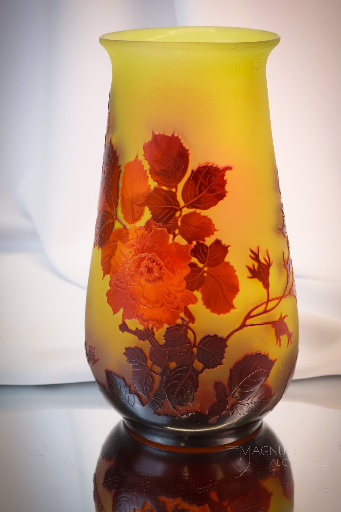 Signed 9 1/2" Galle French Cameo Art Glass Vase: A gorgeous example of a signed Galle' French Cameo art glass vase. This super example features red-orange roses in a glossy finish over a yellow ground. The vase measures 9 1/2" tall and 5 1/2" wide. 