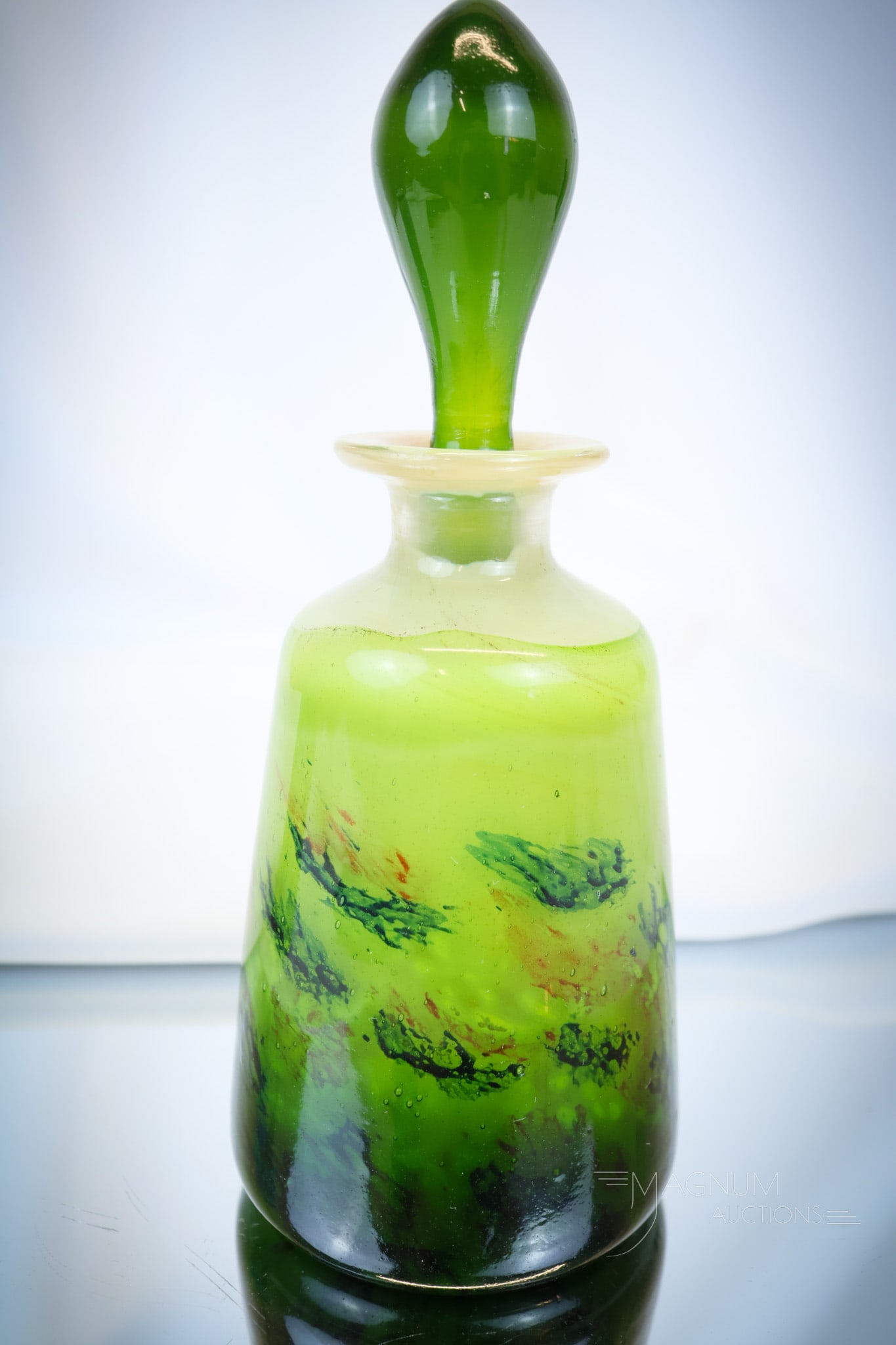 Signed Galle' French Art Glass Perfume Cologne Bottle: Lovely coloring is found on this vibrant and richly colored Galle' signed piece. This perfume or cologne bottle measures 7 1/2" tall and 3" wide. It is complete with the original stopper. Great colori