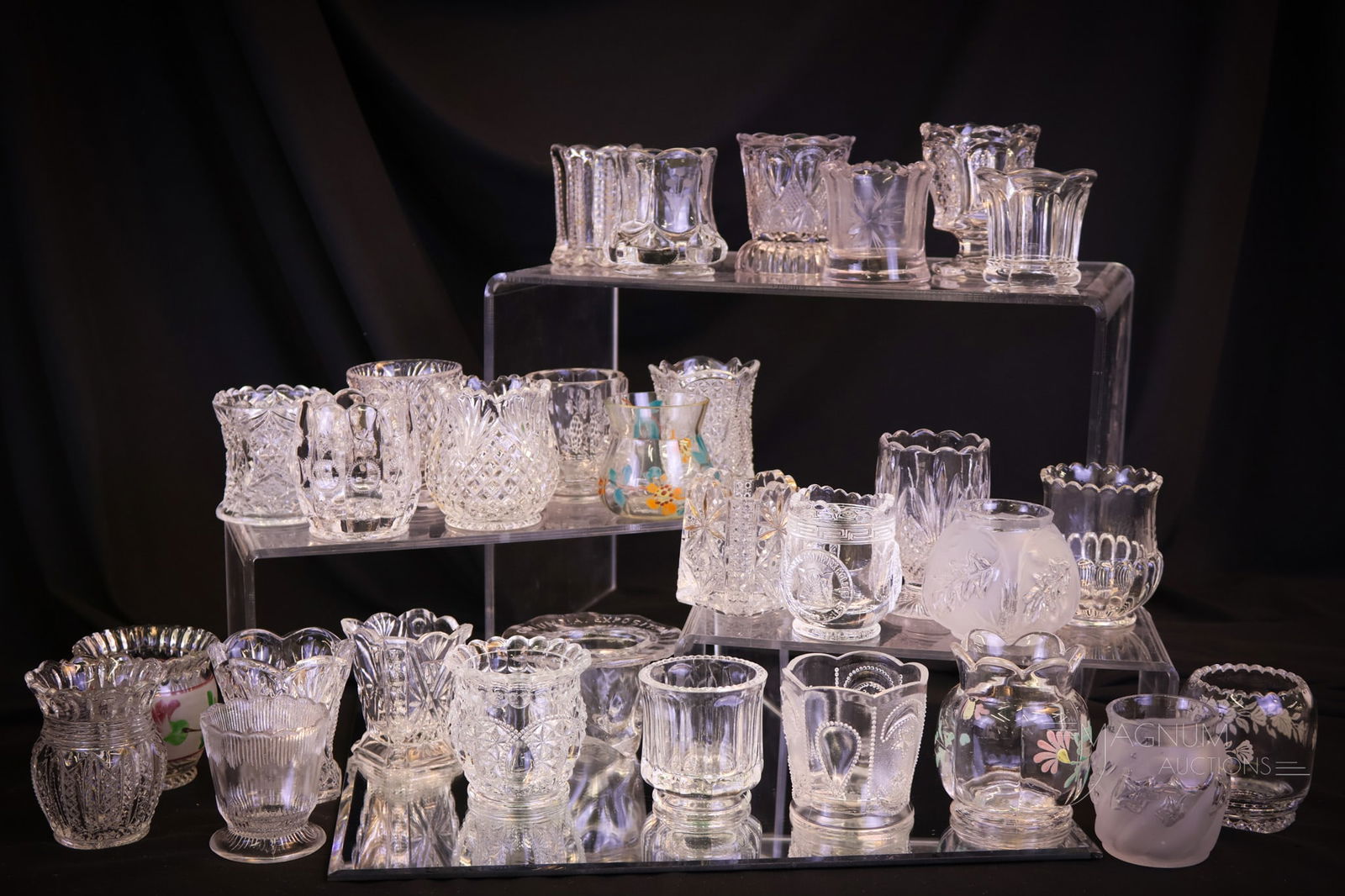 30 Clear Victorian Glass & More Toothpick Holders Riverside Northwood: A super 30-piece lot of Victorian glass and more toothpick holders. This lot includes examples by Northwood and Riverside glass. The tallest measures 3 ". Provenance: This item is from the private co