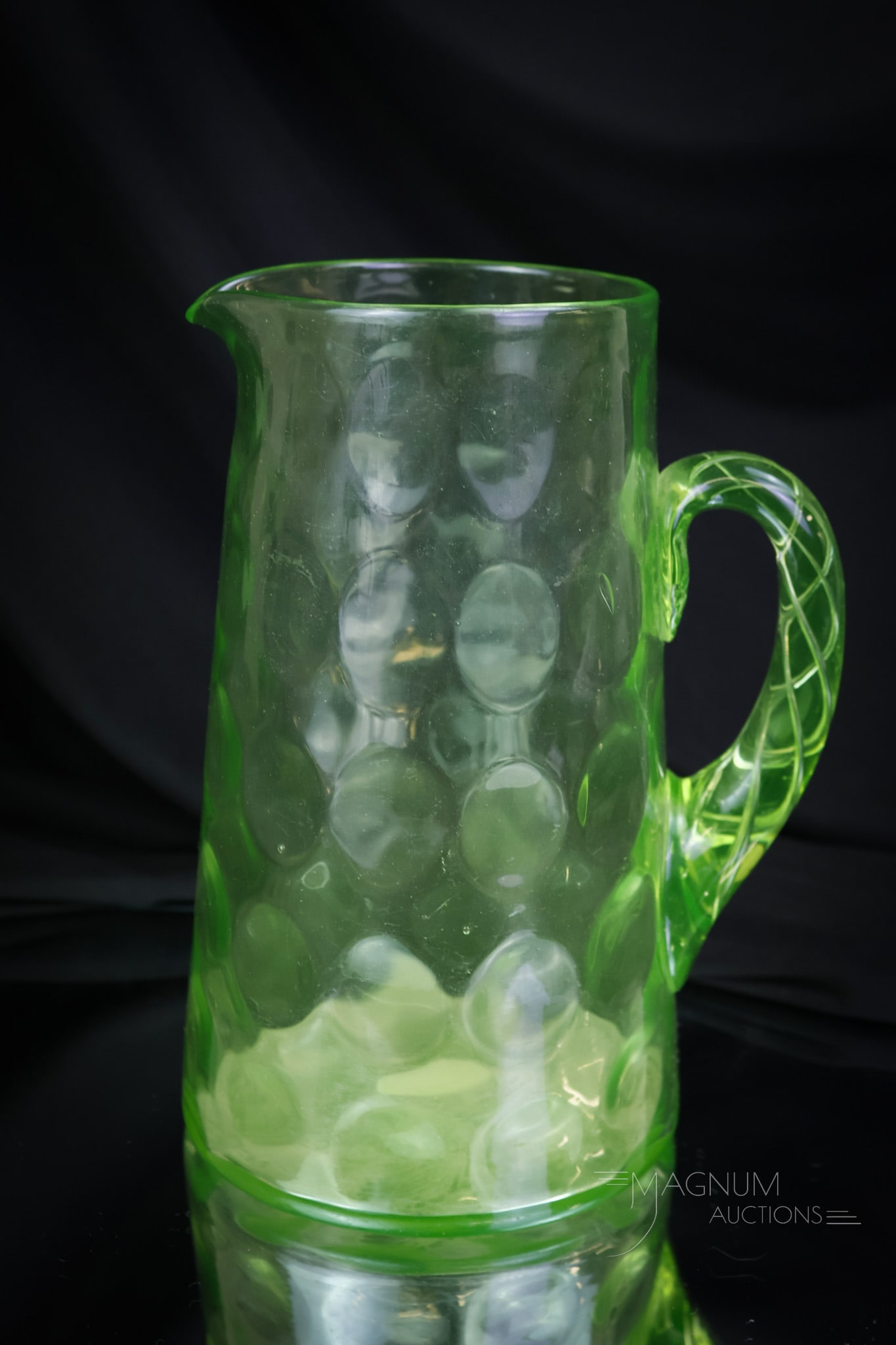 Beaumont Victorian Vaseline Uranium Glass Airtrap Handle Pitcher: A seldom-found and superb example here for your bidding pleasure. This pitcher was made by Beaumont in the inverted thumbprint pattern. The handle features an air trap twist to it. The pitcher measure