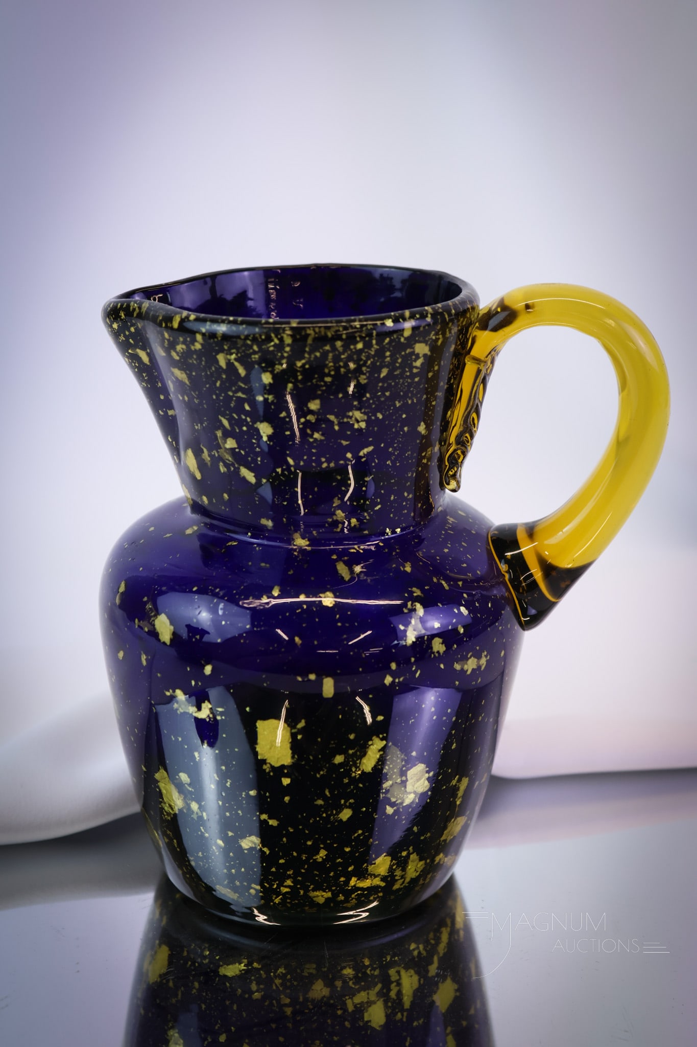 Hobbs Spangle Victorian Glass Water Pitcher: A seldom-found piece of Victorian spangle glass. Folks, this is a nice one. This pitcher by Hobbs is in cobalt glass with amber flakes and handle. The piece measures 7" tall. SHIPPING NOTICE: If you c