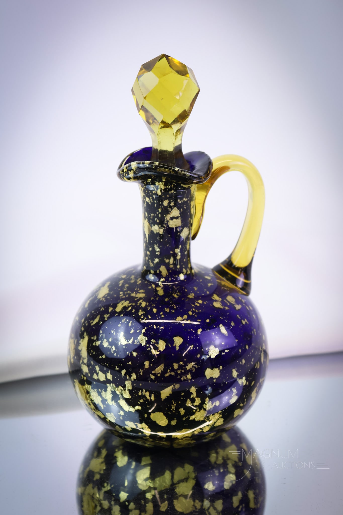 Hobbs Spangle Victorian Glass Cruet: This should liven things up a bit. This cruet is a beautiful addition for the advanced collector. The cruet is made in cobalt with amber spangle and handle. The piece stands 7" tall. SHIPPING NOTICE: 