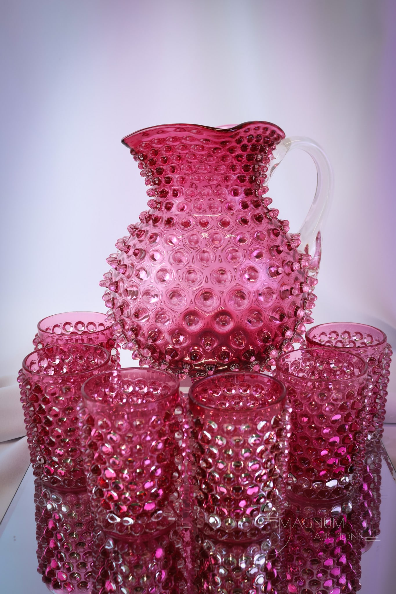 7 pc Hobbs Victorian Cranberry Glass Water Set: A super and beautiful Hobbs cranberry Victorian water set. This set includes a pitcher and six tumblers in the hobnail pattern. Each piece sparkles in the light. The set is complete and ready for your