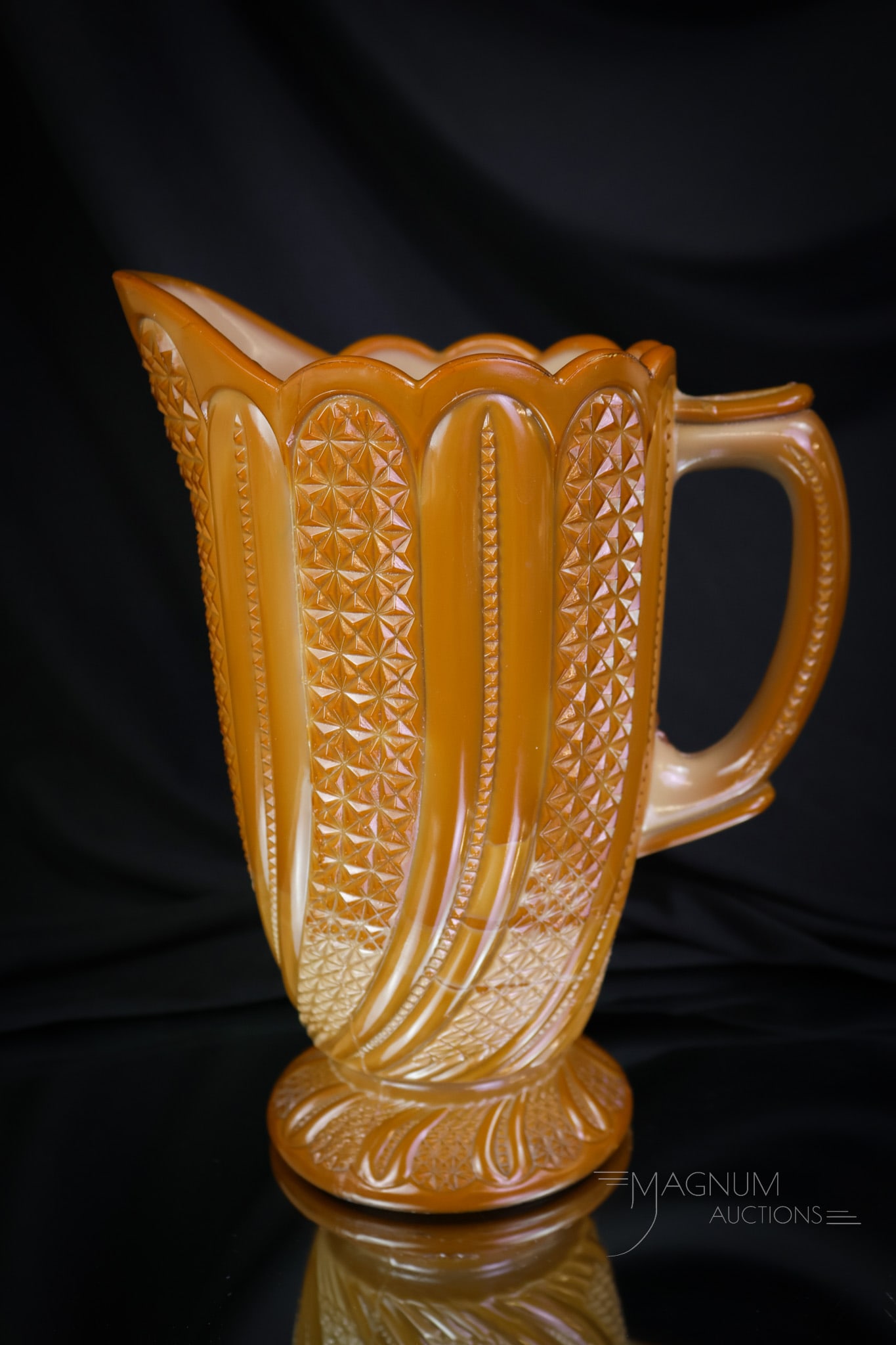 McKee Chocolate Glass Victorian Water Pitcher: A fine example of the highly collectible McKee Feather pattern in the form of a water pitcher. This piece has super coloring and excellent pattern definition. The pitcher measures 8 1/2" tall. A coupl