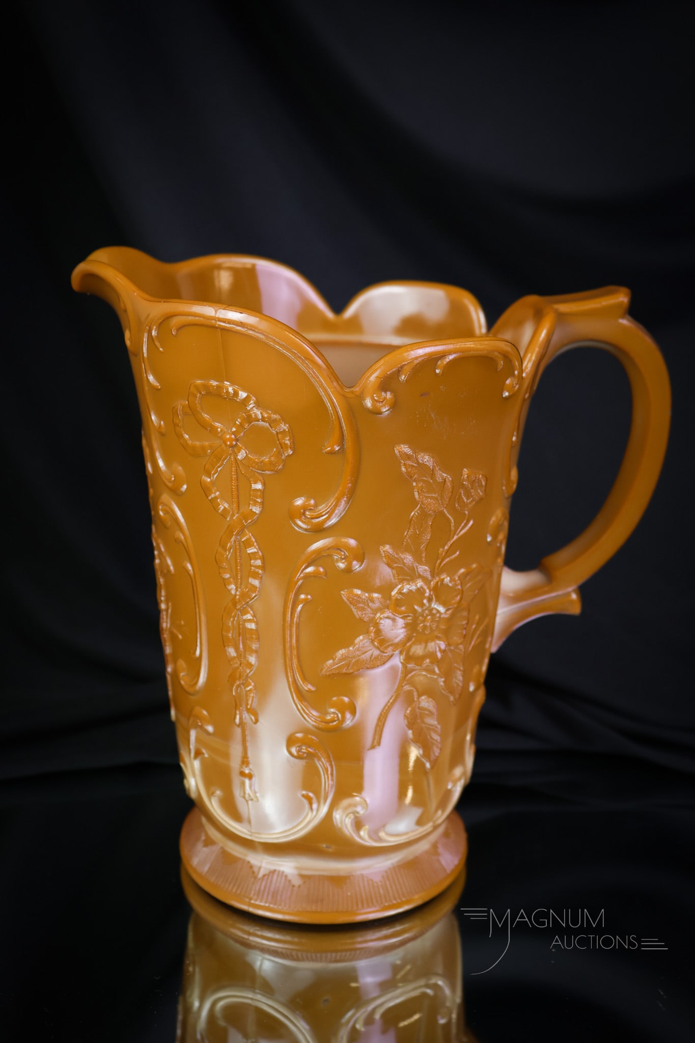 McKee Wild Rose & Bowknot Victorian Chocolate Glass Water Pitcher: Isn't this one nice? This beautiful and desirable water pitcher has the best coloring. This pitcher by McKee is in the Wildrose with Bowknot pattern. The pitcher measures 8" tall. SHIPPING NOTICE: If 