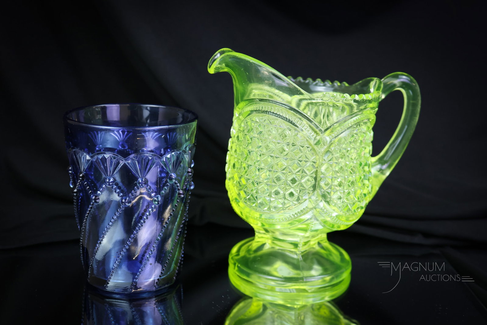 2 pc Lot Greentown Victorian Vaseline Uranium Glass & More: Two desirable finds in Victorian Greentown glass. This lot includes a uranium-rich vaseline Austrian pattern creamer and a blue Cord Drapery pattern tumbler. The tallest measures 5 1/2" tall. SHIPPING