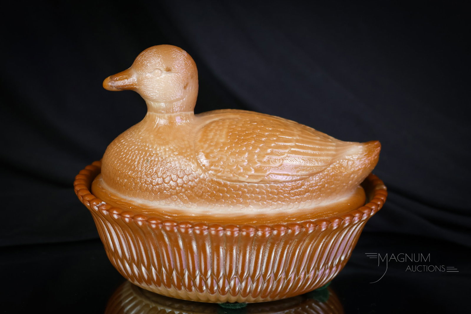 McKee Chocolate Victorian Glass Covered Duck Dish: A cute find in McKee Victorian Chocolate Glass. This is the covered duck dish with extra nice coloring. Complete, the duck dish measures 4 1/2" tall and 6" wide. Two rim chips are noted on the base. S