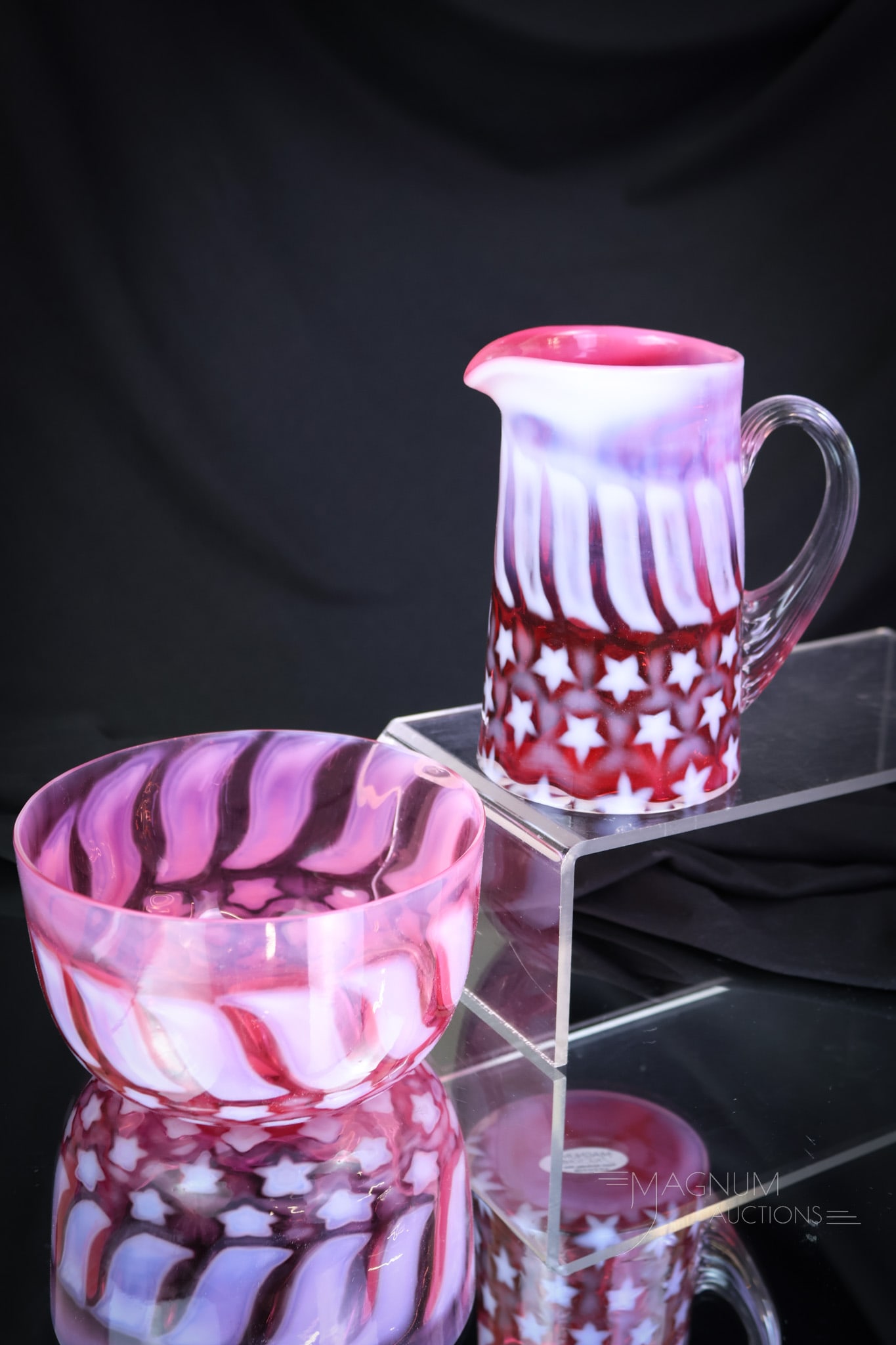 2 pc Lot Fenton LG Wright Cranberry Opalescent Glass: Two patriotic examples of Fenton for L.G. Wright glass in cranberry opalescent. This lot offers a creamer and a bowl. The tallest measures 4 1/2". SHIPPING NOTICE: If you choose not to utilize the Liv