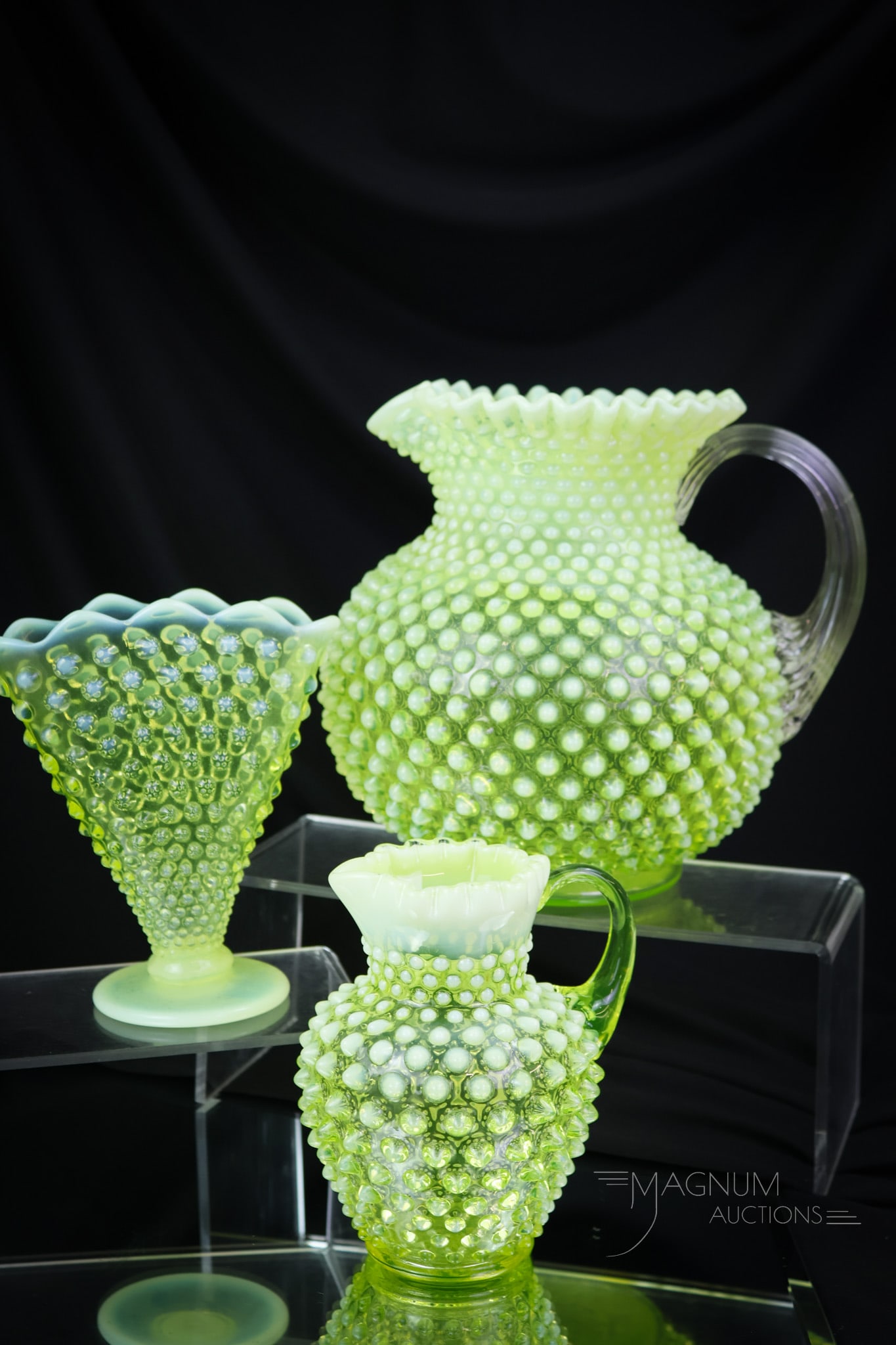 3 pc Lot Fenton Topaz Vaseline Uranium Opalescent Art Glass: Three shiner-lovin' pieces of Fenton uranium-rich vaseline opalescent topaz glass all in the Hobnail pattern. This lot includes a scarce ball-form jug, a fan vase, and, lastly, a cream pitcher. The ta