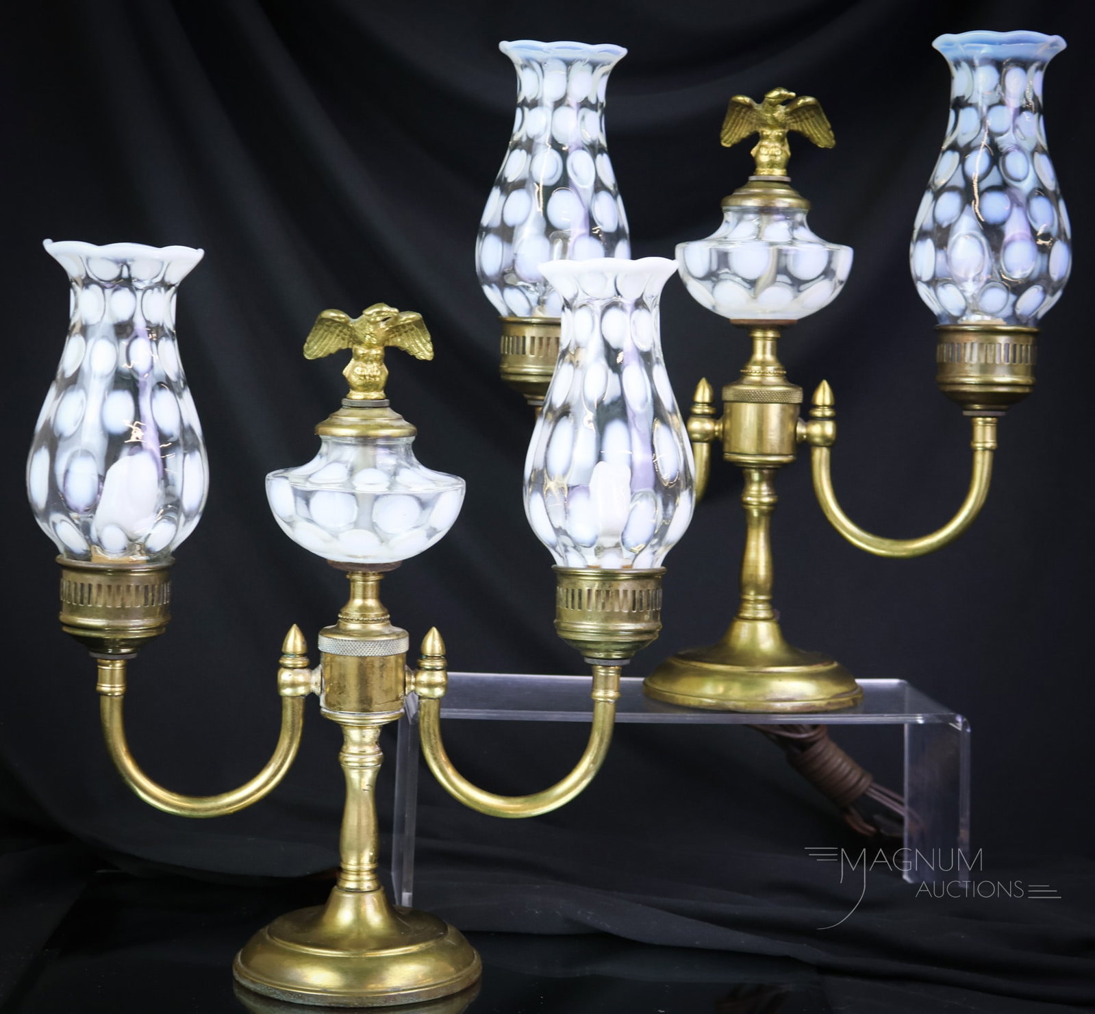 Pair Fenton Coinpsot Opalescent Art Glass Table lamps: A select pair of French opalescent Fenton art glass table lamps. Each features opalescent components and eagle finial in the center of each. Each lamp measures 12" tall and 11" wide. SHIPPING NOTICE: 