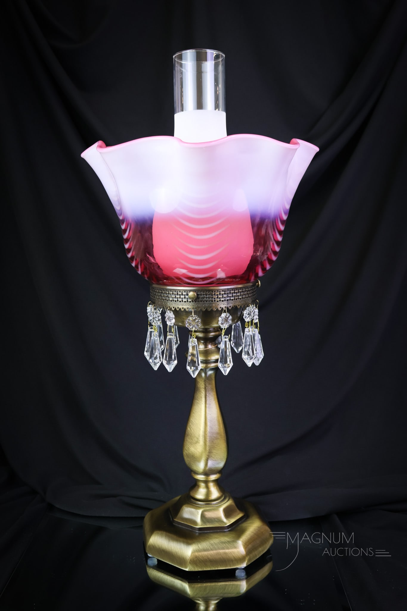 Fenton Cranberry Opalescent Art Glass Drapery Table Lamp: One can almost imagine the grand home this fine piece came out of. This over-the-top lamp is complete with glass prisms hanging from the hardware. Nice! The lamp measures 17" tall. SHIPPING NOTICE: If
