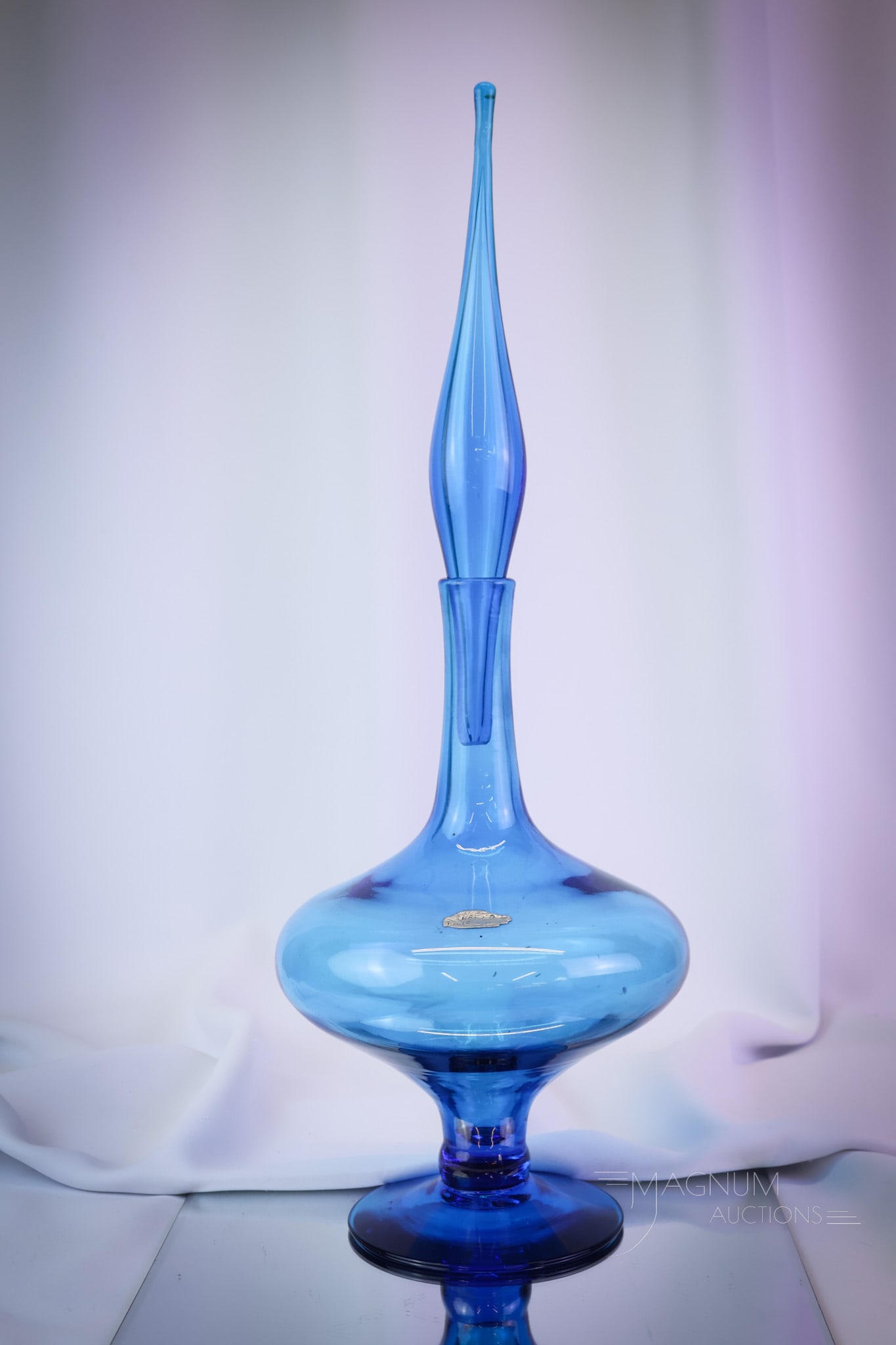 Blenko Art Glass 22" Wayne Husted Decanter: A gorgeous Blenko art glass designed by Wayne Husted decanter. The piece is numbered #6212L and measures a whopping 22" tall and 7 1/2" wide. SHIPPING NOTICE: If you choose not to utilize the LiveAuct