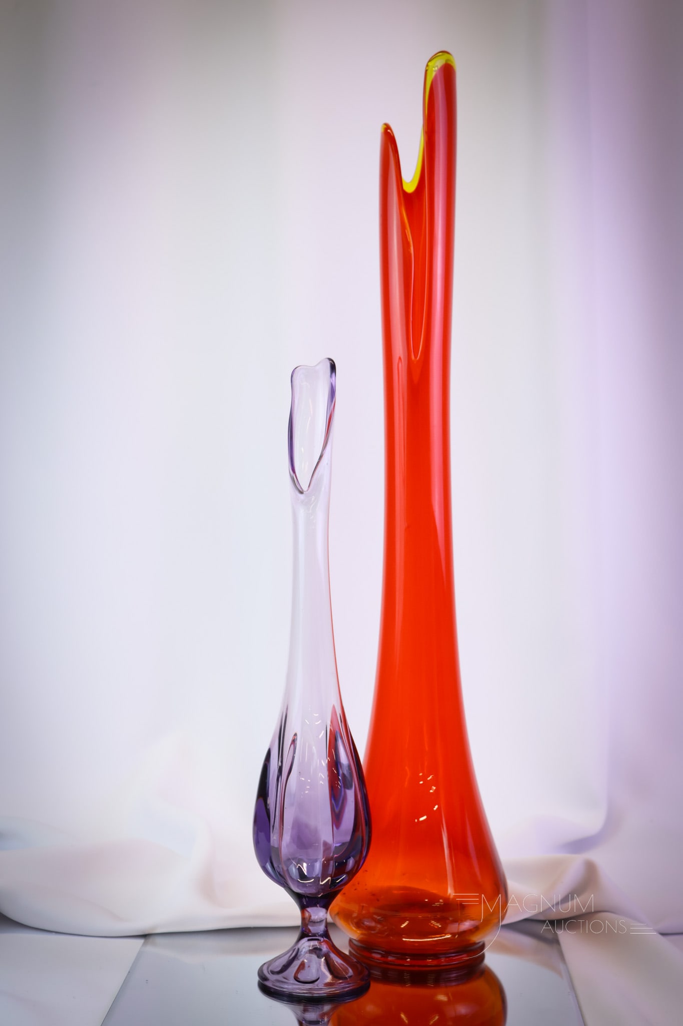 2 pc Lot L.E. Smith & Viking Art Glass Swung Vases: Two delights sure to please the Swingers out there. This lot of two swung vases is simply delightful. The first is an L.E. Smith vase in flame coloring. The second is a Viking art glass with a lobed d