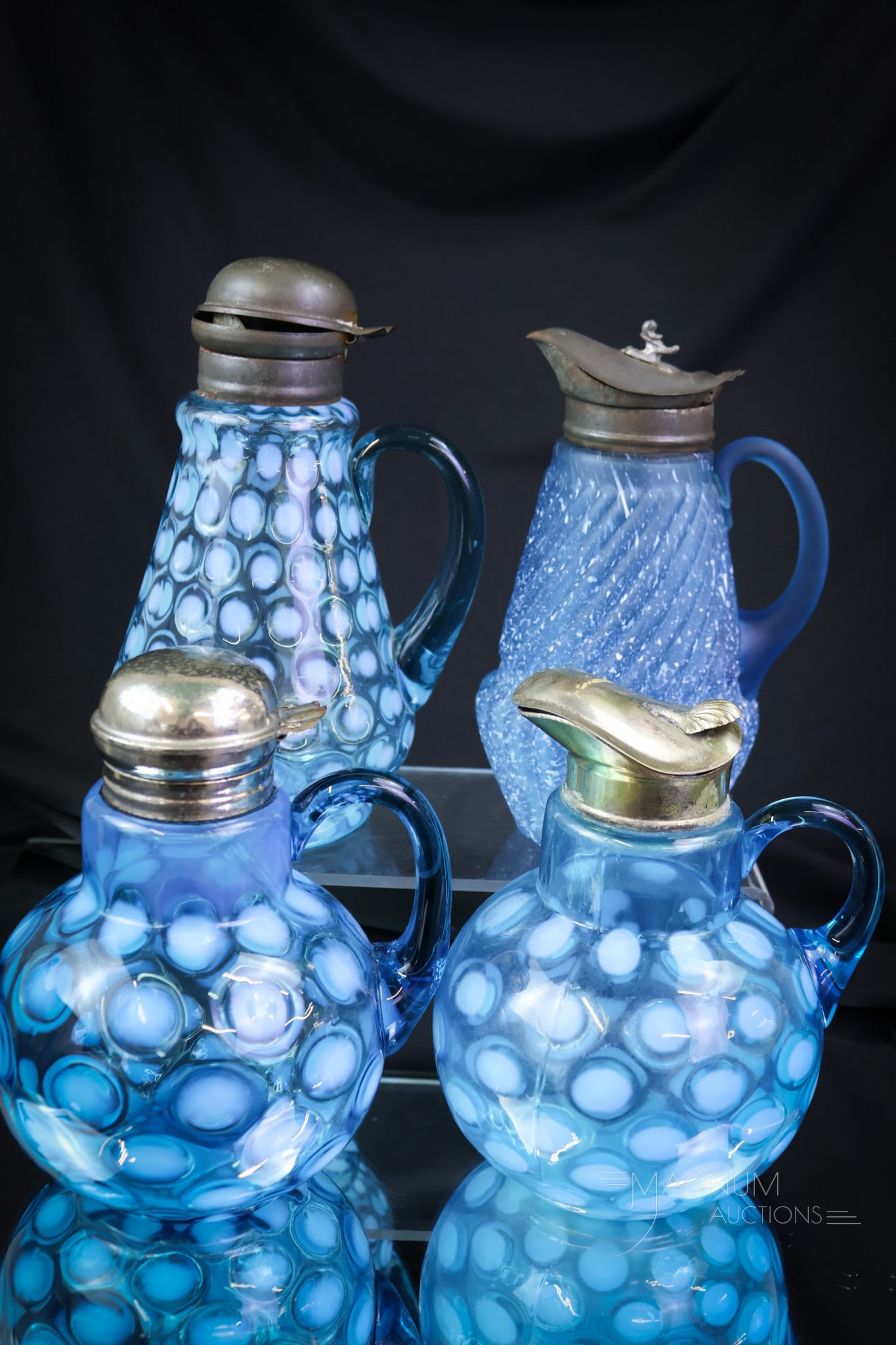 4 pc Lot Victorian Blue Opalescent & More Syrup Pitchers: Four amazing finds in Victorian syrup pitchers. This lot includes makers such as Hobbs, Northwood, and more. The tallest measures 7 1/2". The Chrysanthemum Base Frit finish exhibits a heat check at th