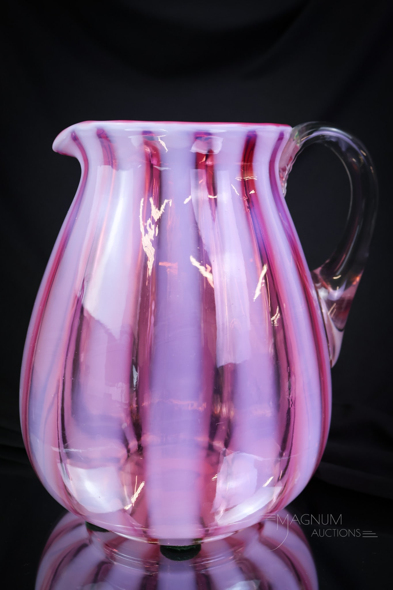 Rare Cranberry Opalescent Nickel Wide Stripe Victorian Water Pitcher: A beautiful and seldom ever found Victorian glass opalescent water pitcher. This one is by Nickel glass. It is made in cranberry opalescent glass in the Stripe pattern. The pitcher measures 7 3/4" tal