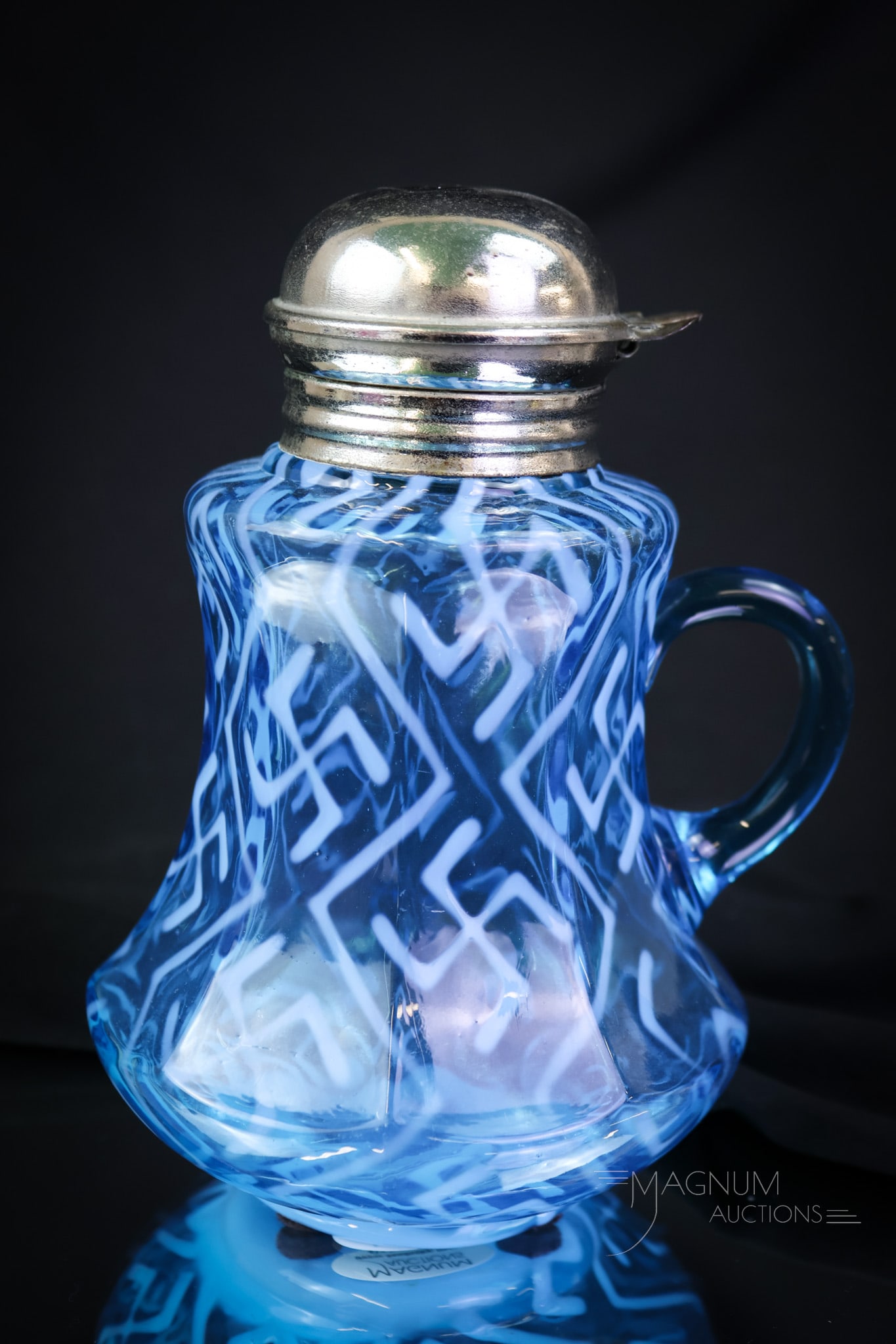 Very Rare Northwood Swastika Blue Opalescent Glass Syrup Pitcher: A very rare offering of a Northwood blue opalescent Swastika pattern syrup pitcher. This fine example is in the nine-panel mold. A rare, rare syrup. Make way on the shelf for this super piece. It will