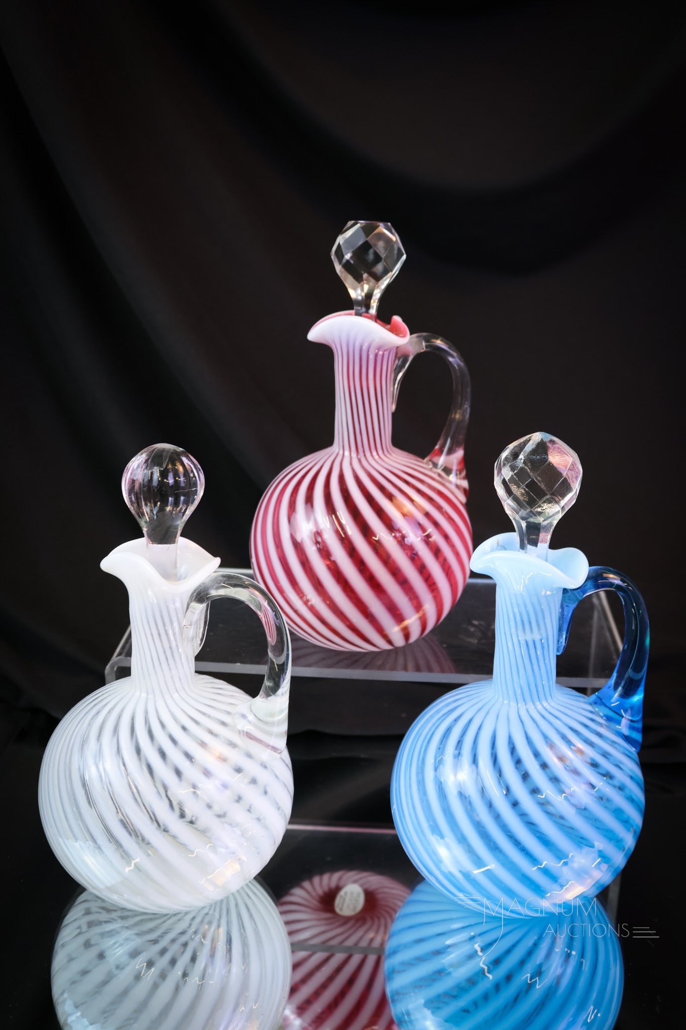 3 pc Lot Hobbs Swirl Victorian Cranberry Blue Opalescent Glass Cruets: Three Hobbs cruetsthat are sure to bring a smile to your face. We have combined the cranberry, blue, and crystal opalescent examples for your bidding pleasure. Each is a fantastic example of Victorian