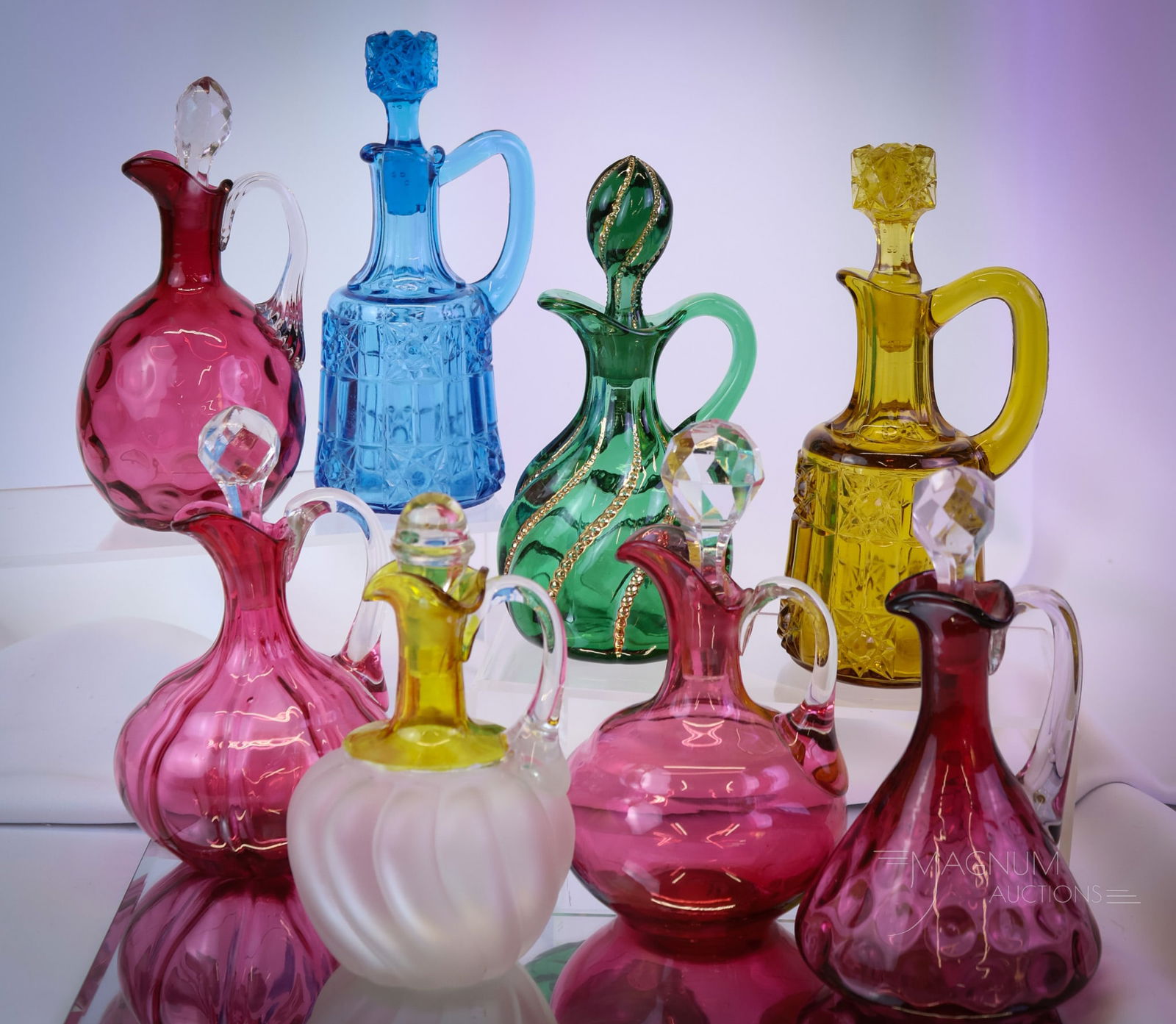 8 pc Lot Victorian Glass Cranberry Amber Blue Green Cruets: Eight delights in Victorian glass to sparkle in your collection. This lot offers an array of patterns and colors to please anyone. The tallest measures 7 1/2". SHIPPING NOTICE: If you choose not to ut