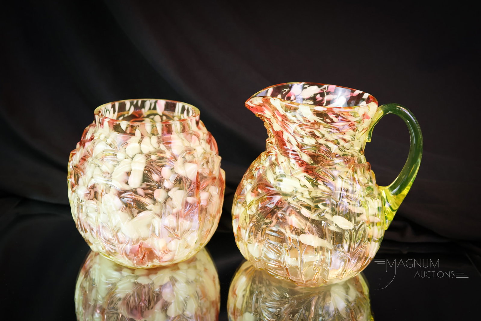 Northwood Vaseline Cranberry uranium Spatter Glass Leaf Mold Creamer & Spooner: A pairing of two lovely pieces of Victorian Northwood cranberry vaseline uranium-rich spatter glass. This lot offers a creamer along with a spooner. The tallest measures 4 1/2". A tiny rim chip is not