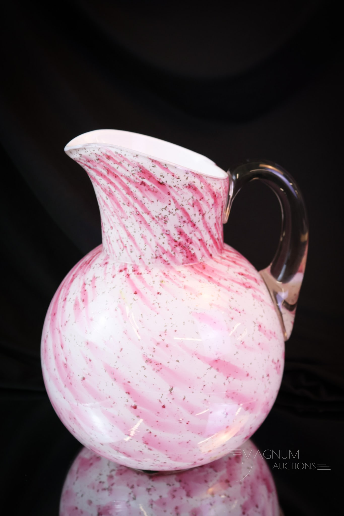 Rare Northwood Prima Donna Victorian Cranberry Spatter Water Pitcher: A rare find in Northwood glass. This pattern is called Prima Donna. Rarely do pieces surface. This pitcher has excellent cranberry coloring and mica spatter. The pitcher measures 9" tall and 7" wide. 